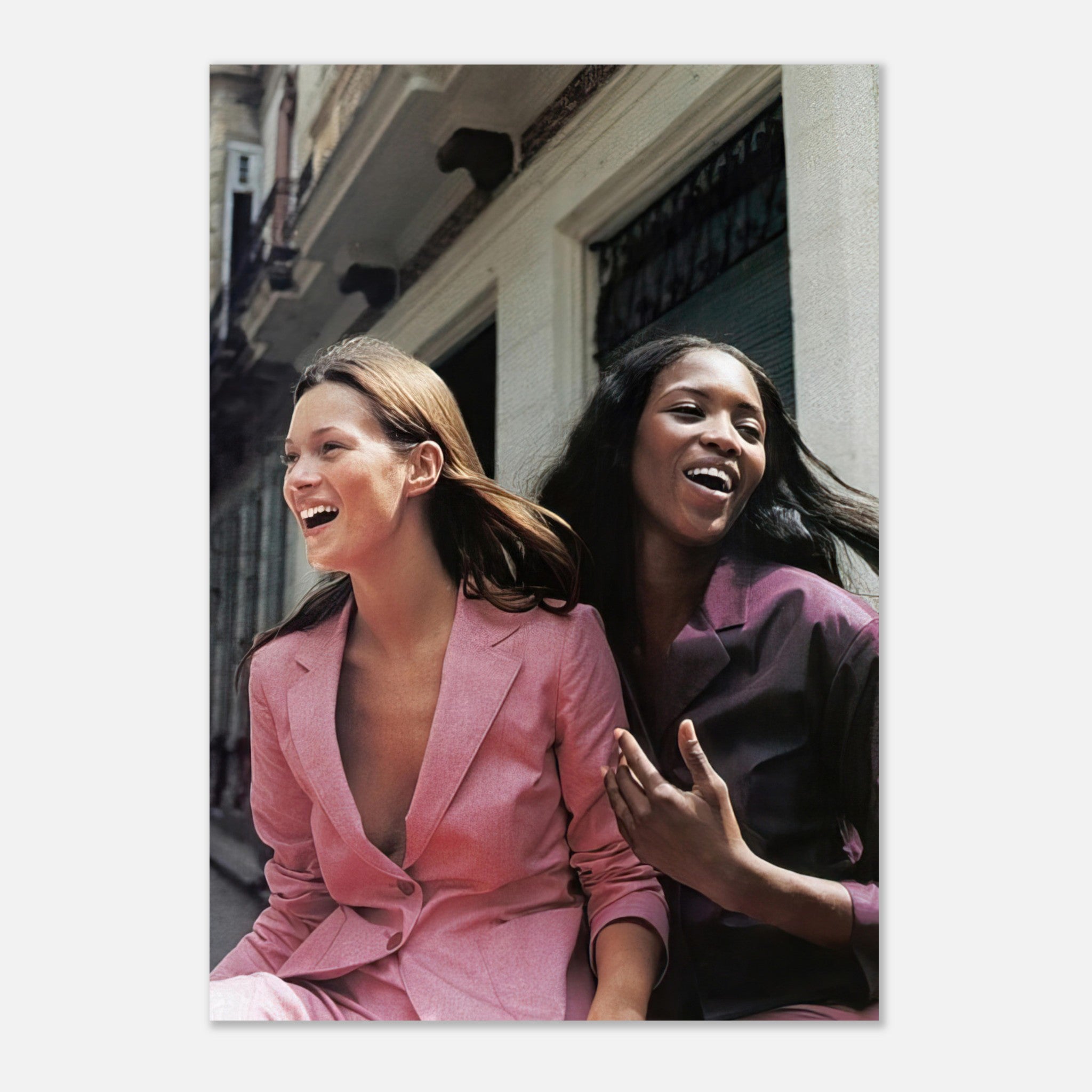Naomi Campbell x Kate Moss poster capturing joyful candid moment in stylish outfits, showcasing iconic fashion elegance.