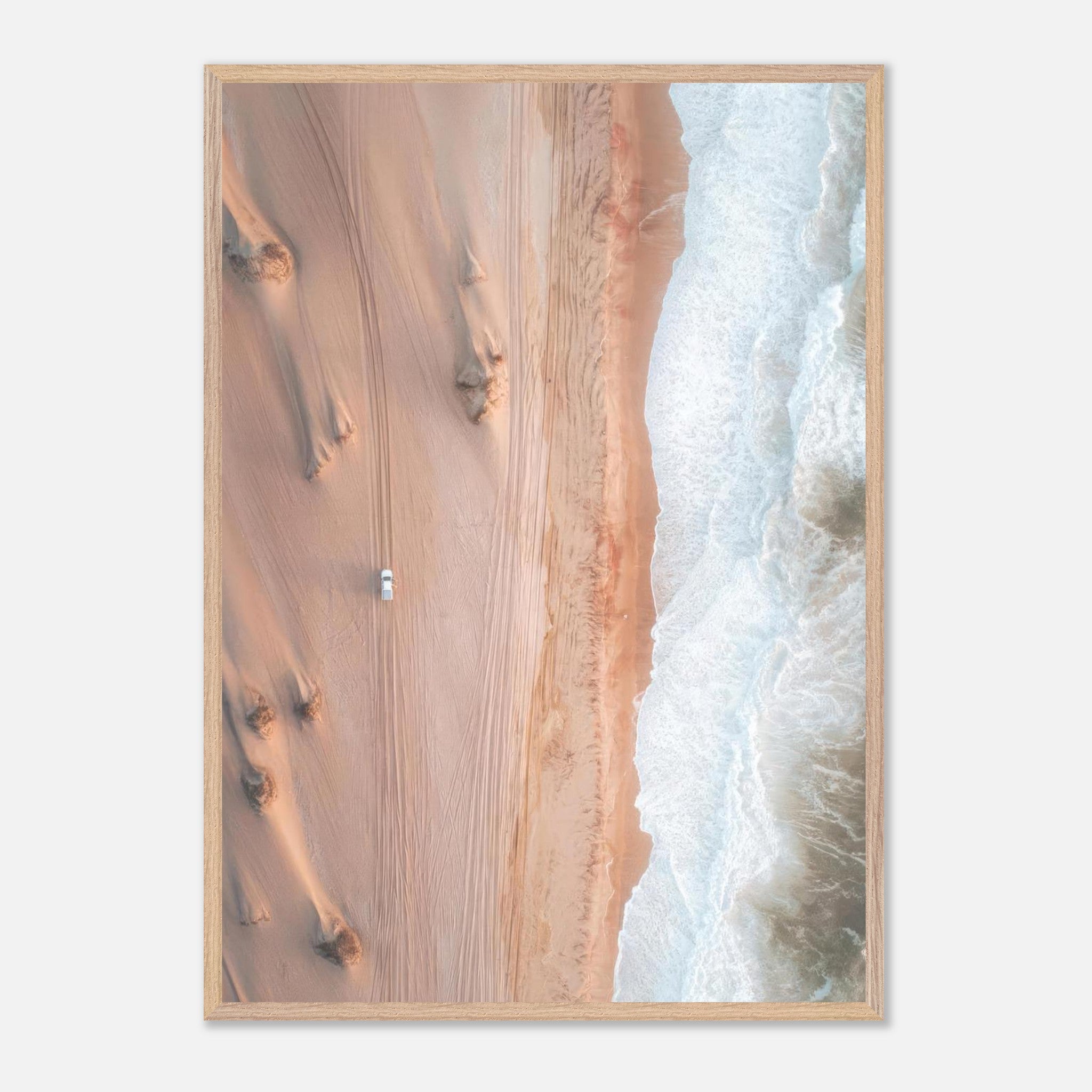 Stunning aerial view of desert dunes meeting ocean waves in a vintage framed print.