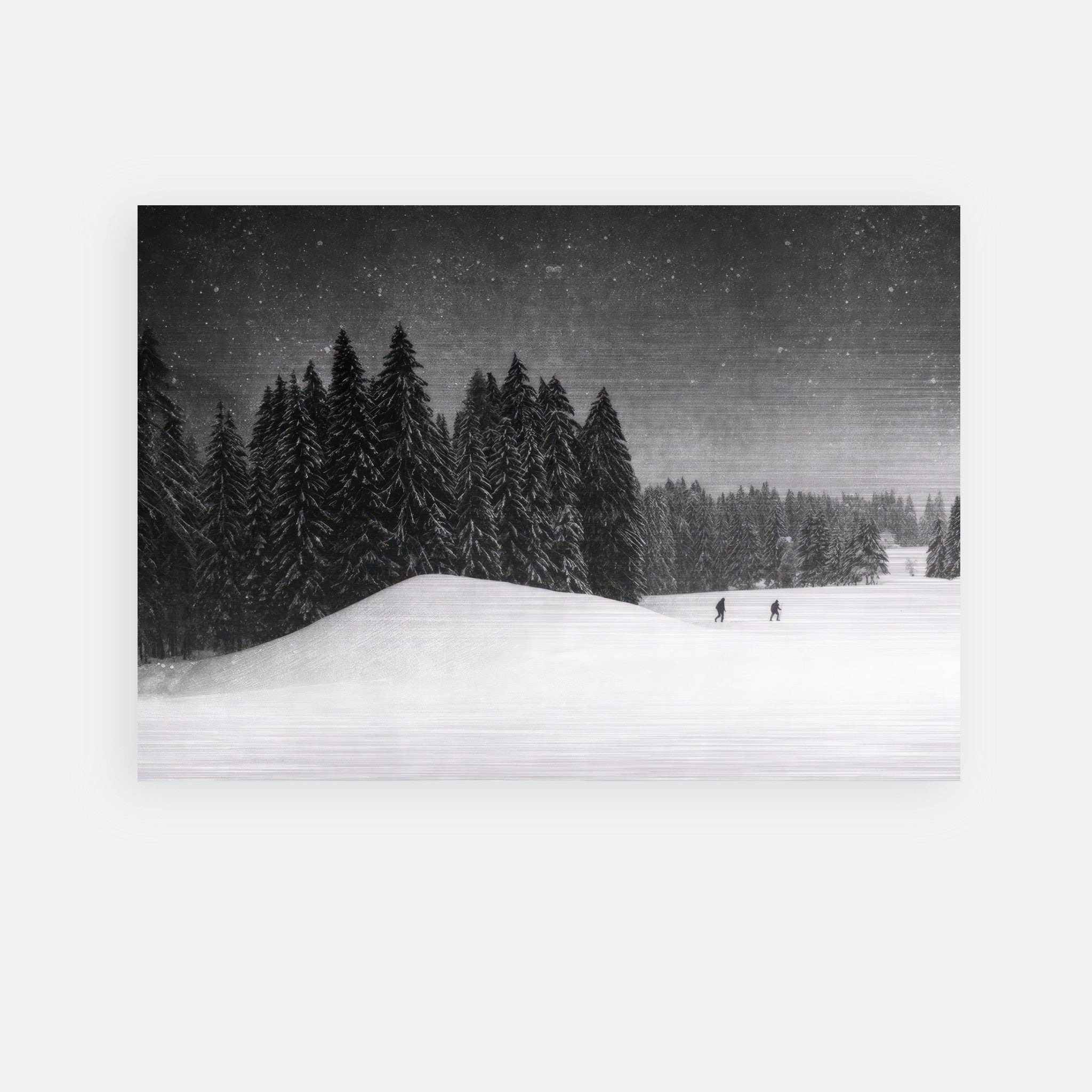 Winter Crossing brushed metal artwork featuring a snowy landscape with evergreen trees and two figures walking.