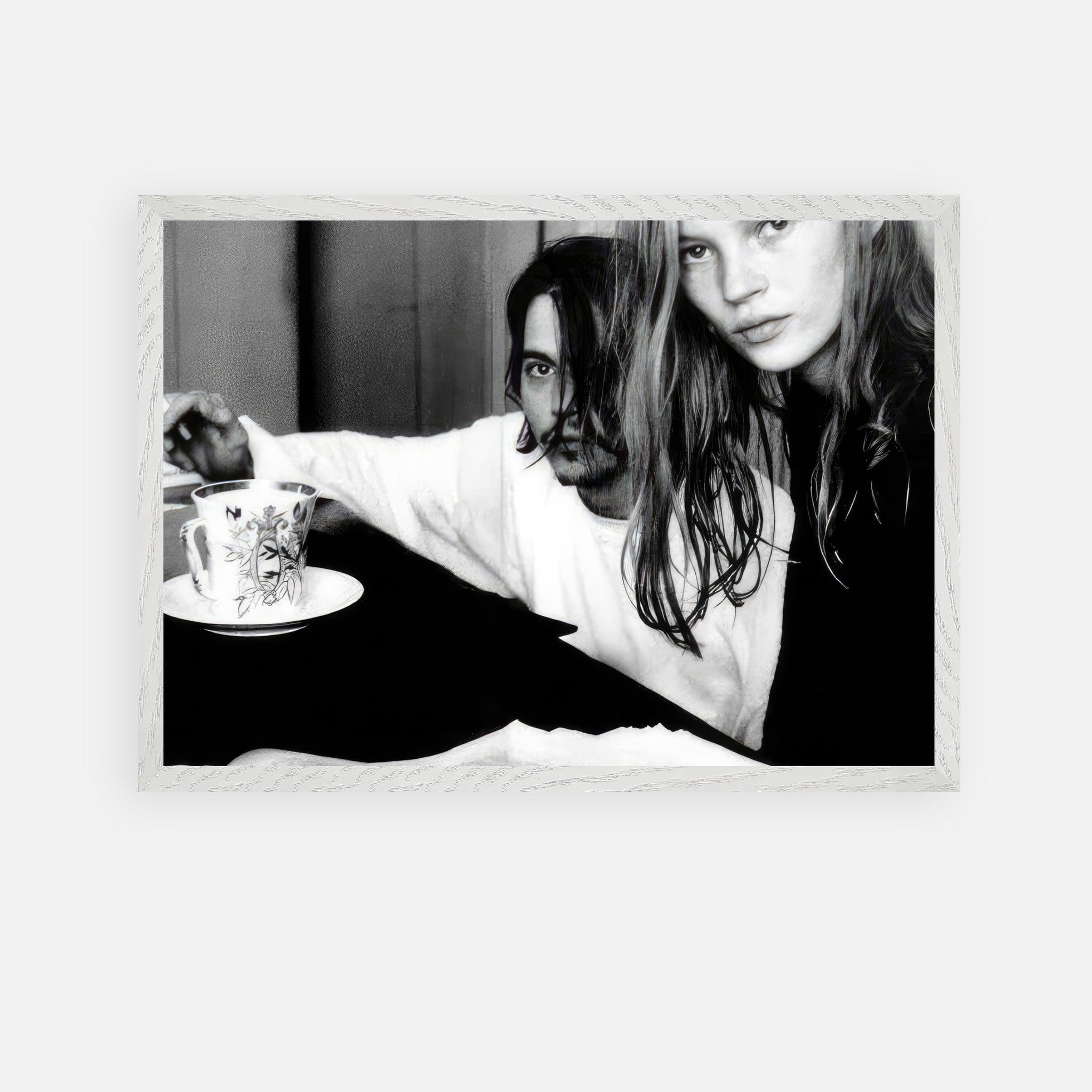 Vintage framed art of Johnny Depp and Kate Moss, a 90s romance captured in black-and-white photography.