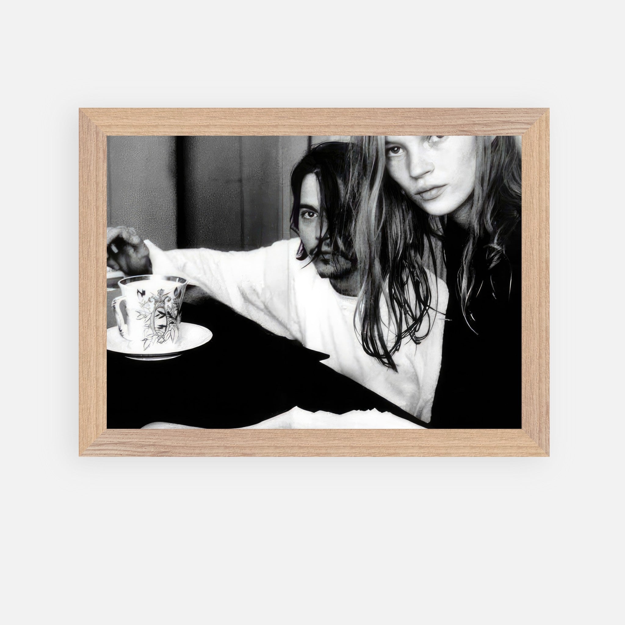 Framed black-and-white portrait of Johnny Depp and Kate Moss, capturing 90s romance and rebellion.