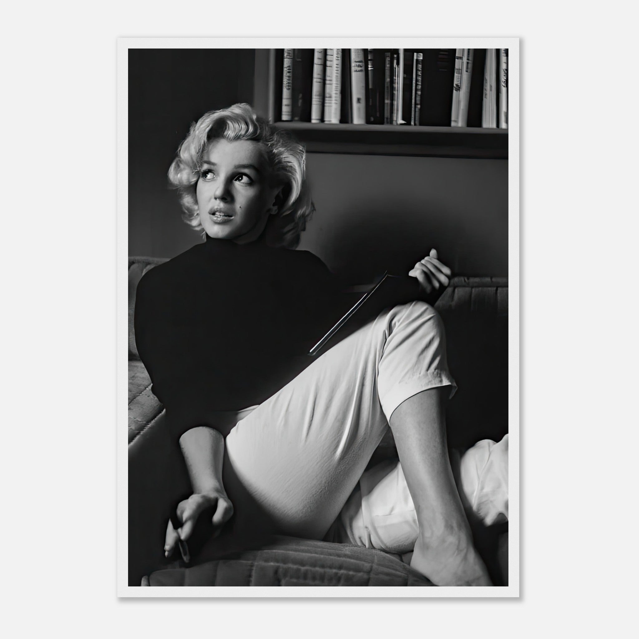 Marilyn Monroe reading a book in black-and-white, exuding timeless elegance in a framed print.