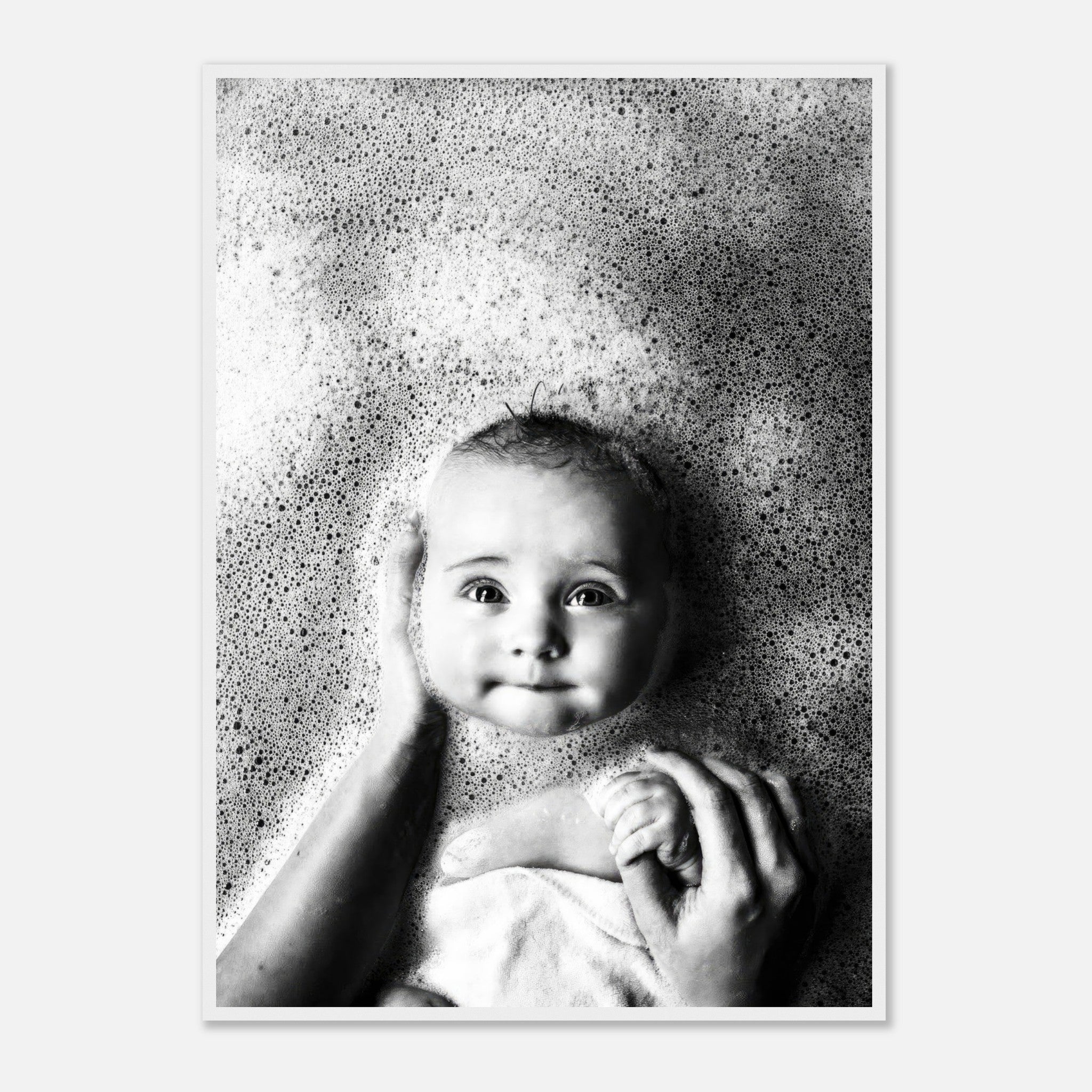 Black-and-white baby bath photography framed print, capturing joy and innocence surrounded by bubbles.