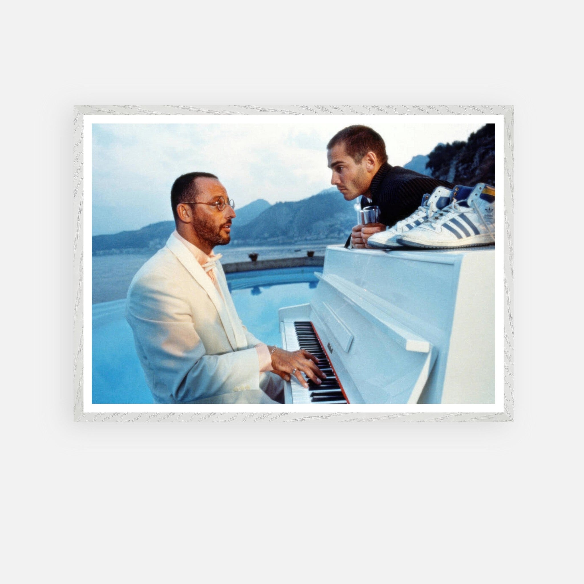 Jean Reno playing piano by the pool in *The Big Blue*, showcasing cinematic elegance and coastal beauty. Fine art print.