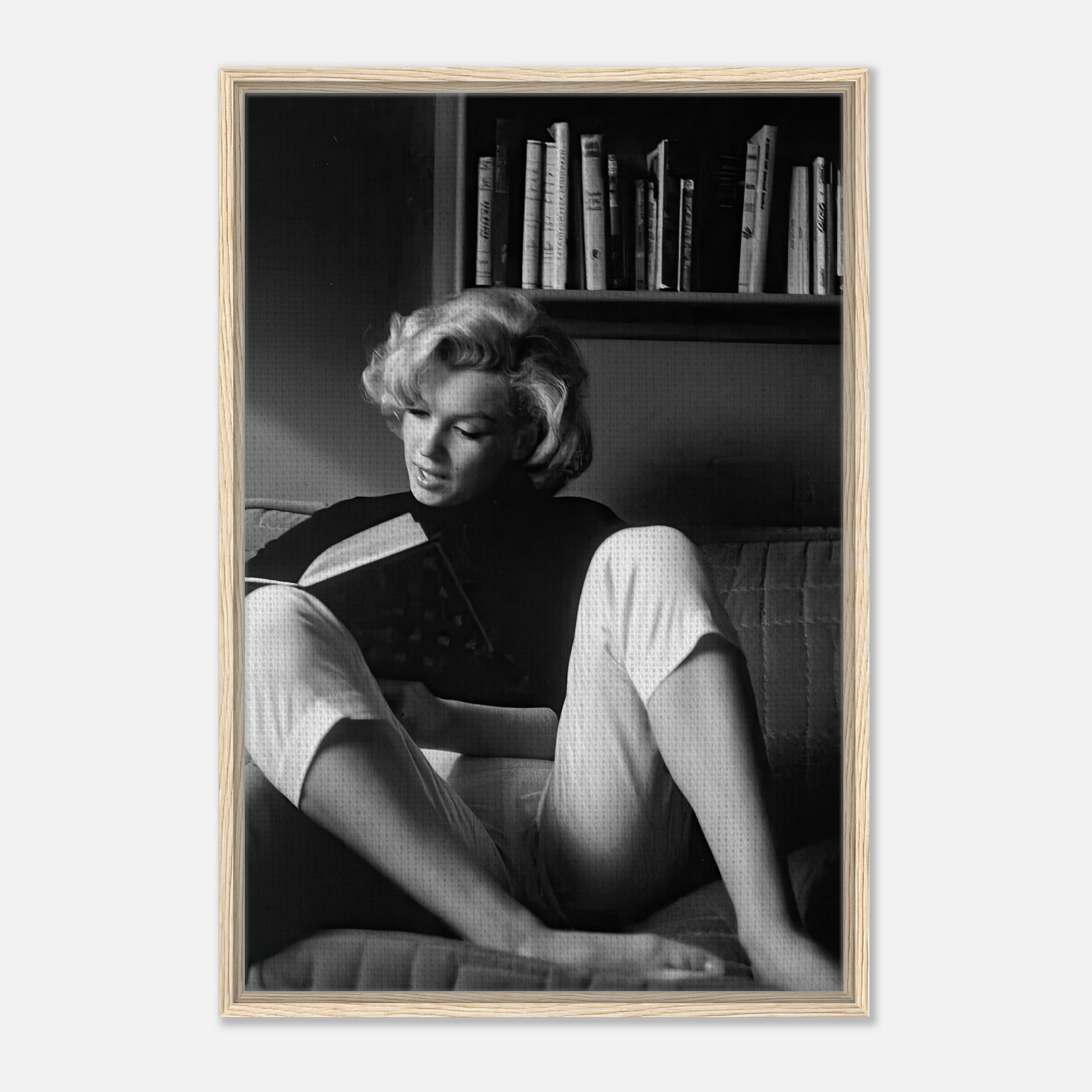 Marilyn Monroe reading at home, framed canvas art capturing her elegance in a serene moment.