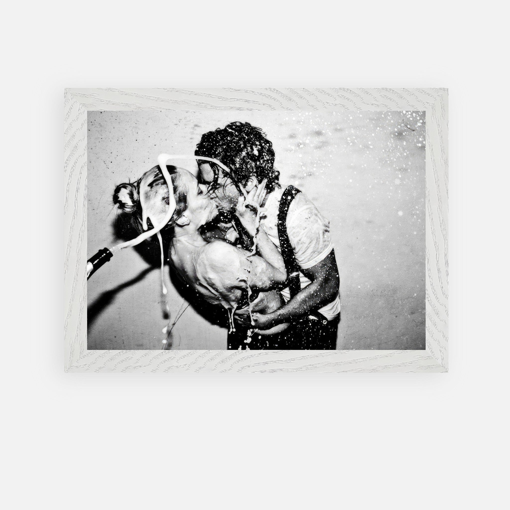 Black-and-white vintage framed art of a passionate kiss with champagne by Johnny Depp and Kate Moss.