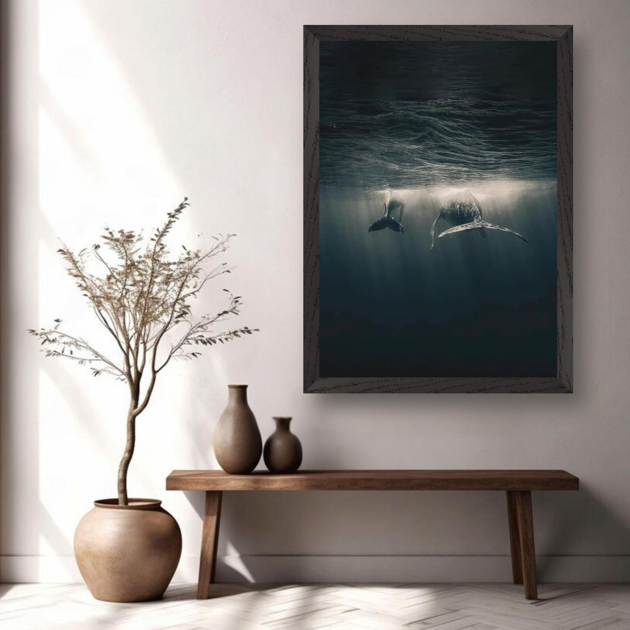 Vintage framed print of whales swimming underwater, creating a serene oceanic atmosphere in home decor.