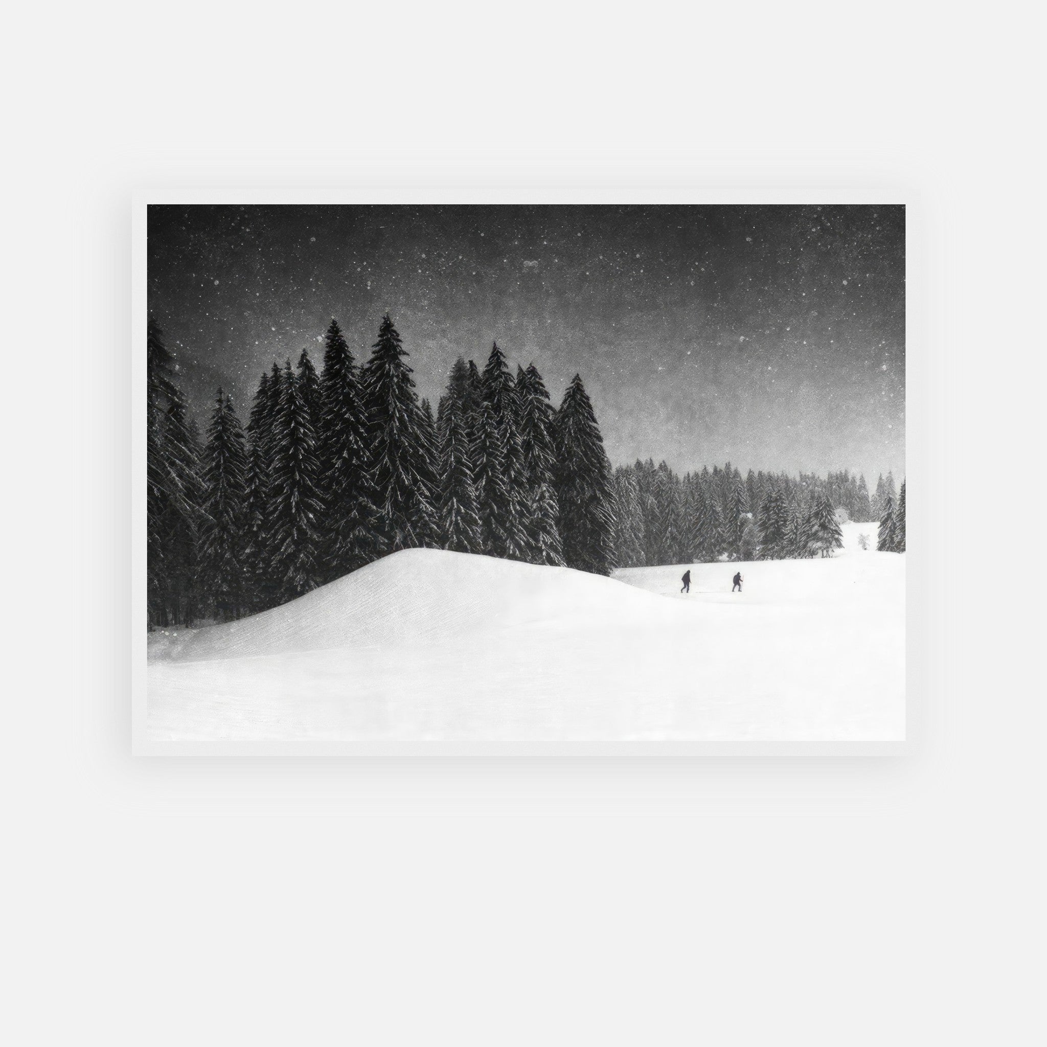 Winter Crossing framed print showcasing a serene black-and-white forest covered in snow with snowflakes falling.