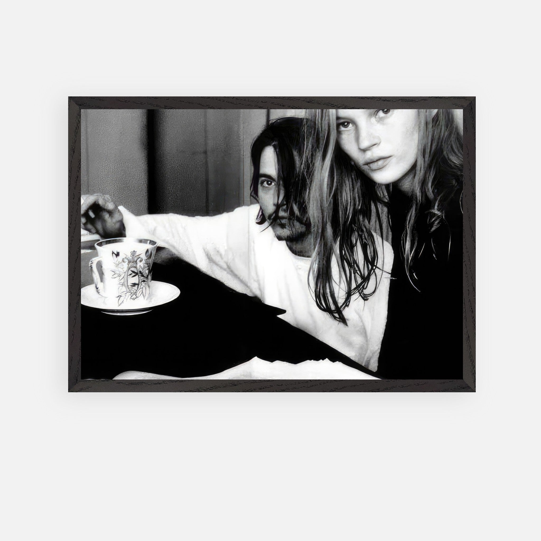 Vintage framed art of Johnny Depp and Kate Moss, capturing 90s rebellion and romance in black-and-white photography.