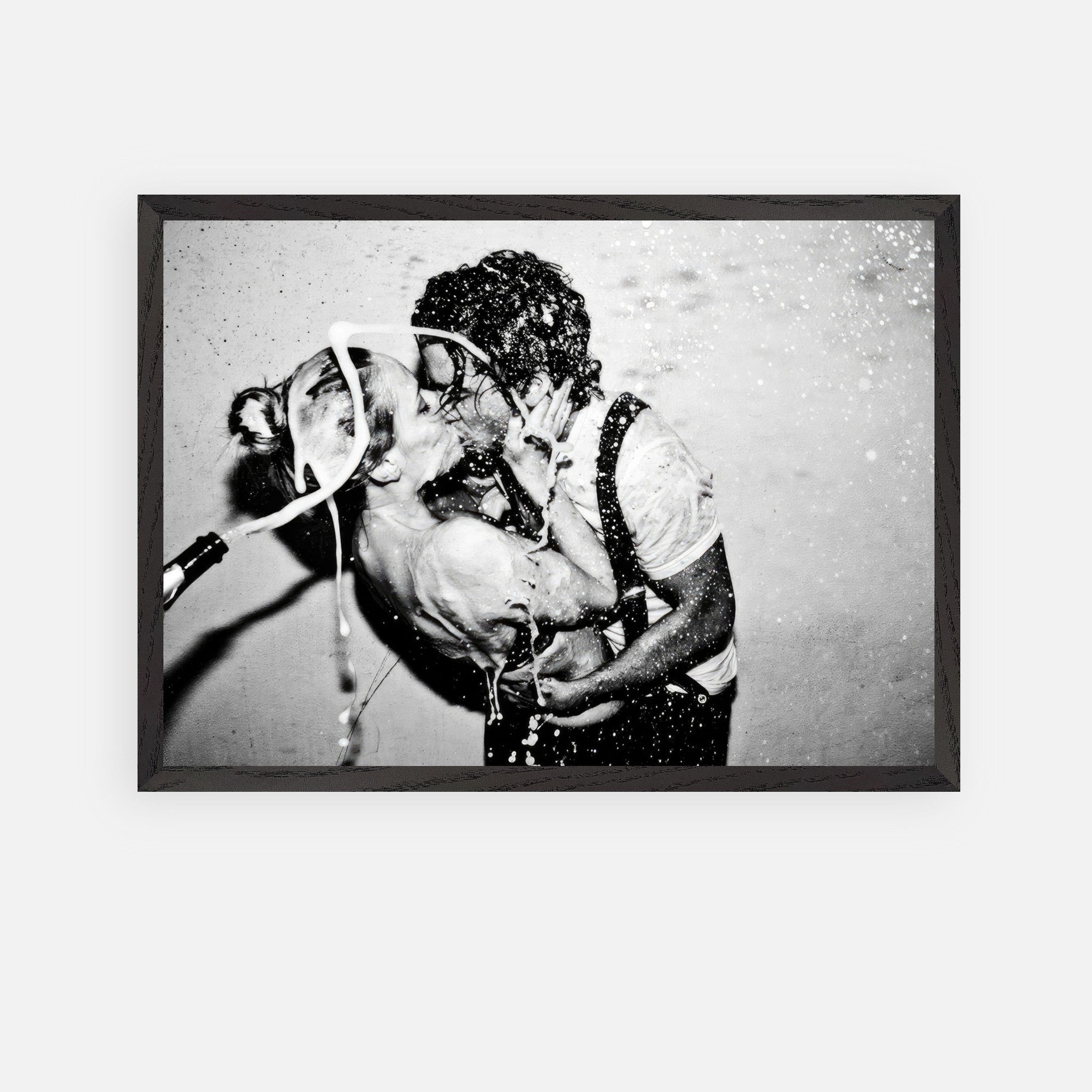 Vintage framed art featuring a passionate kiss between Johnny Depp and Kate Moss with champagne splashing.