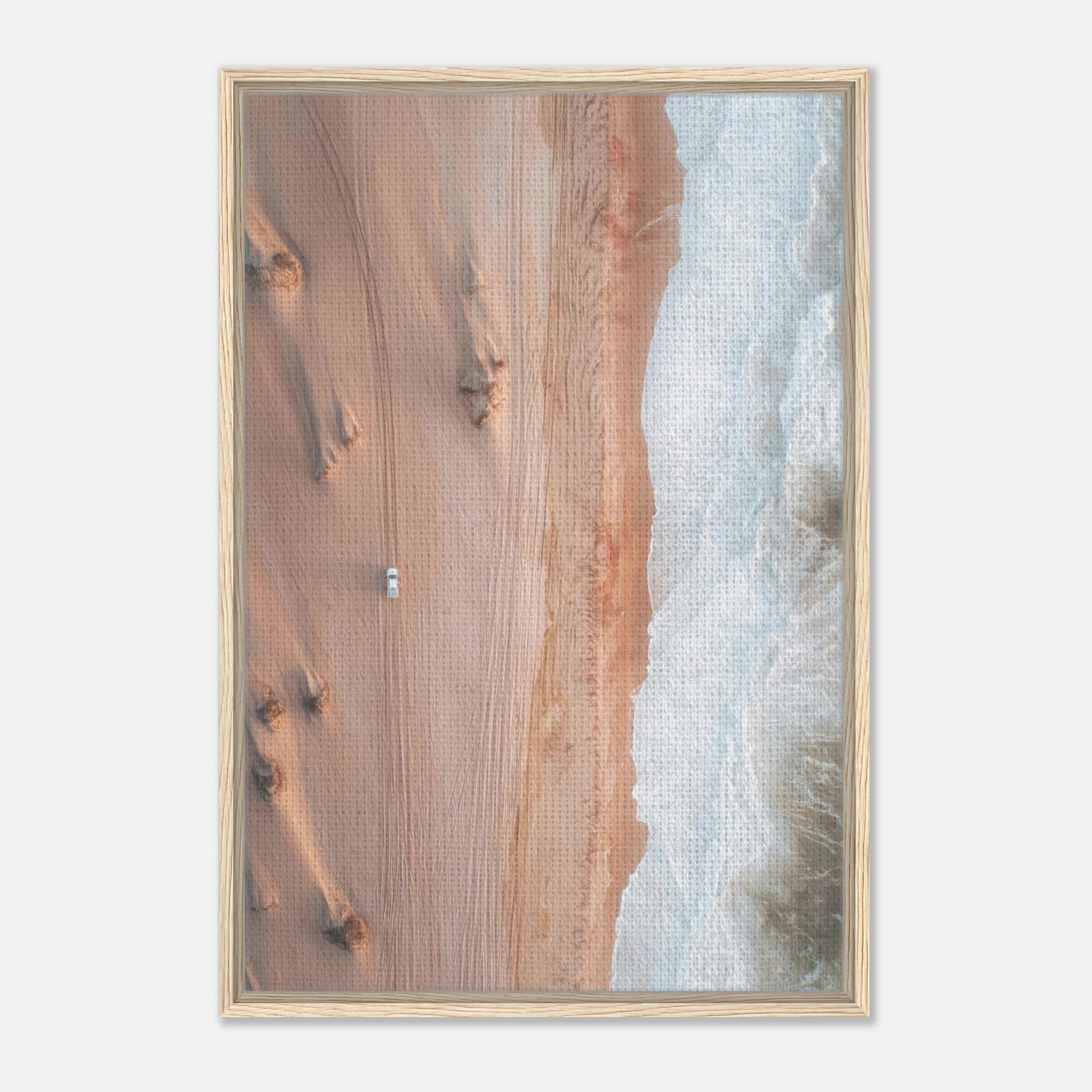 Framed canvas print of drone photography showing desert sand dunes meeting the ocean waves.