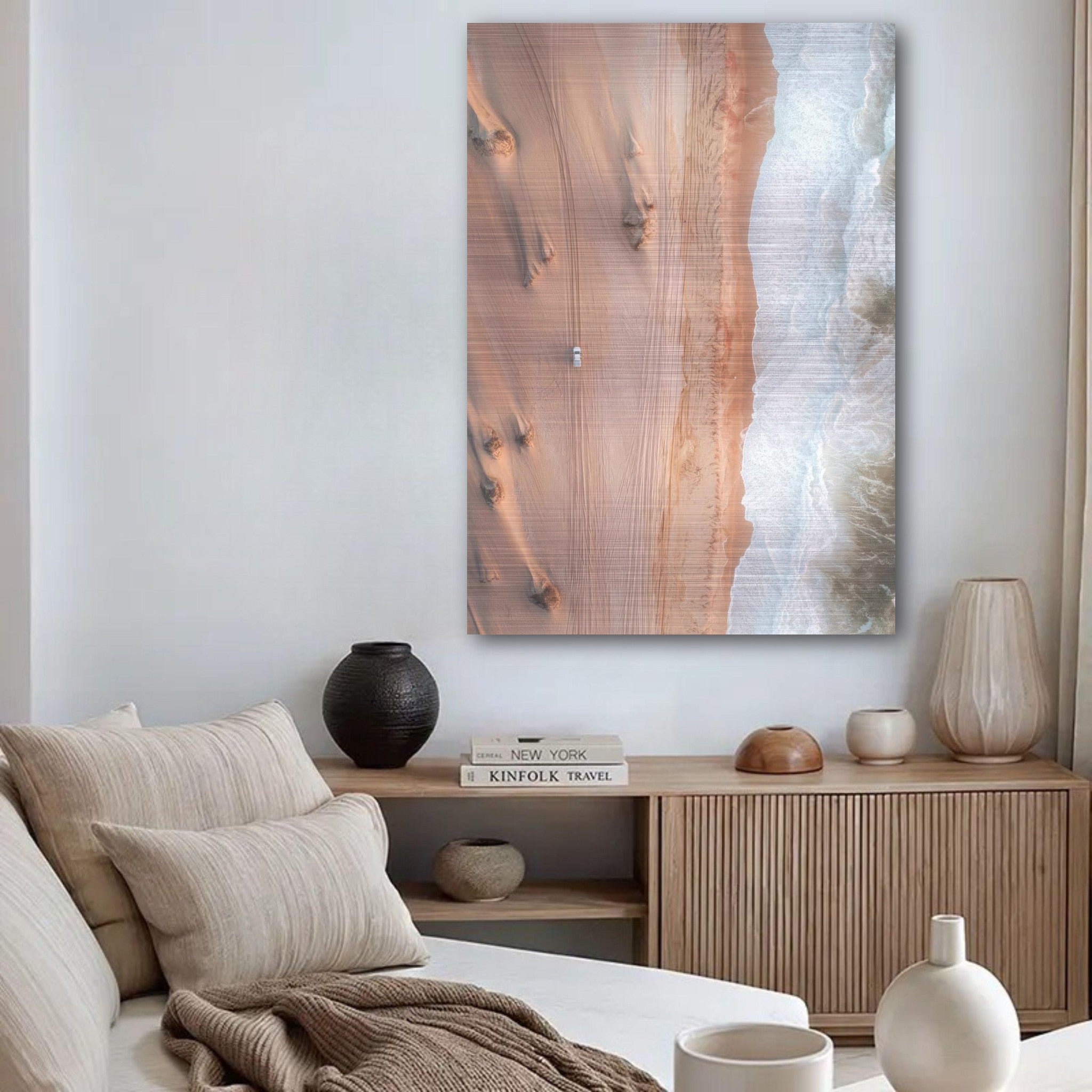 Brushed metal print 'Where Desert Meets Ocean' showcasing desert dunes meeting ocean waves in a stylish living room.