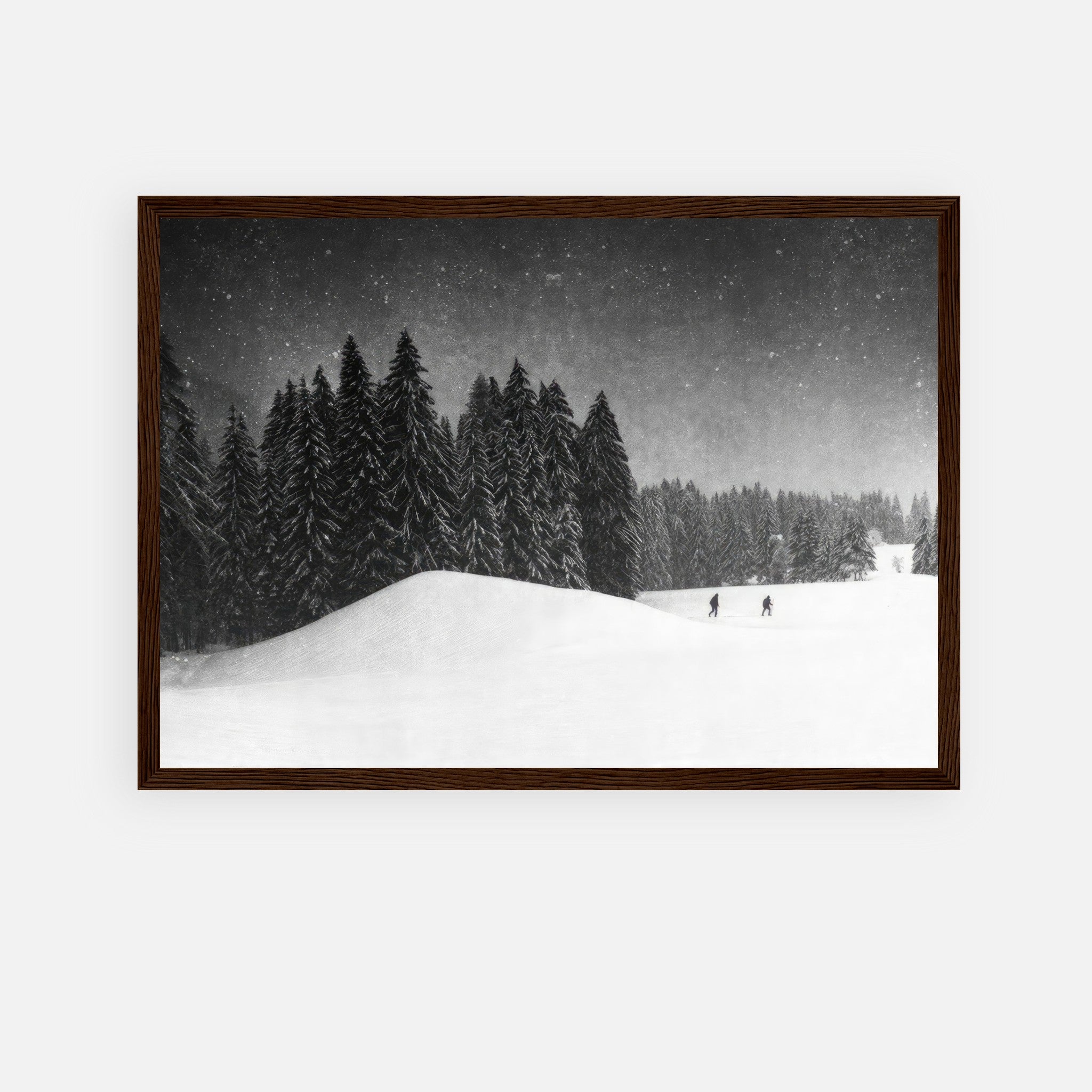 Winter Crossing framed print featuring a serene snow-blanketed forest with skiers and towering evergreens.