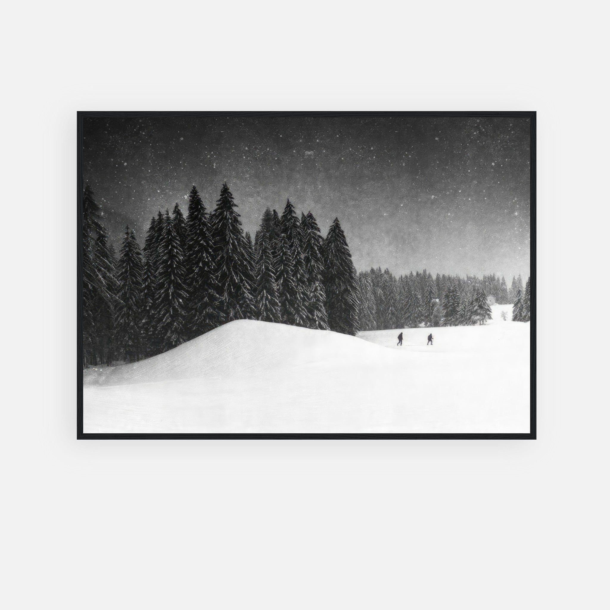 Black-and-white framed print of a serene snow-covered forest with skiers, titled Winter Crossing.