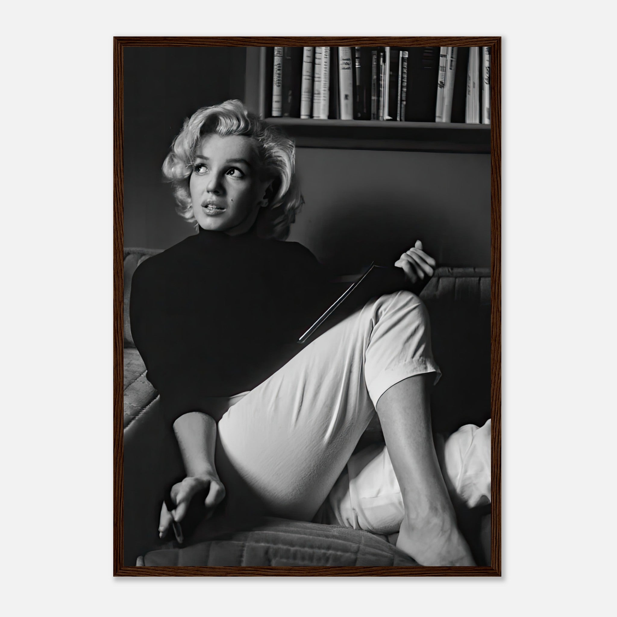 Marilyn Monroe reading a book in a black-and-white framed print, exuding vintage glamour and elegance.
