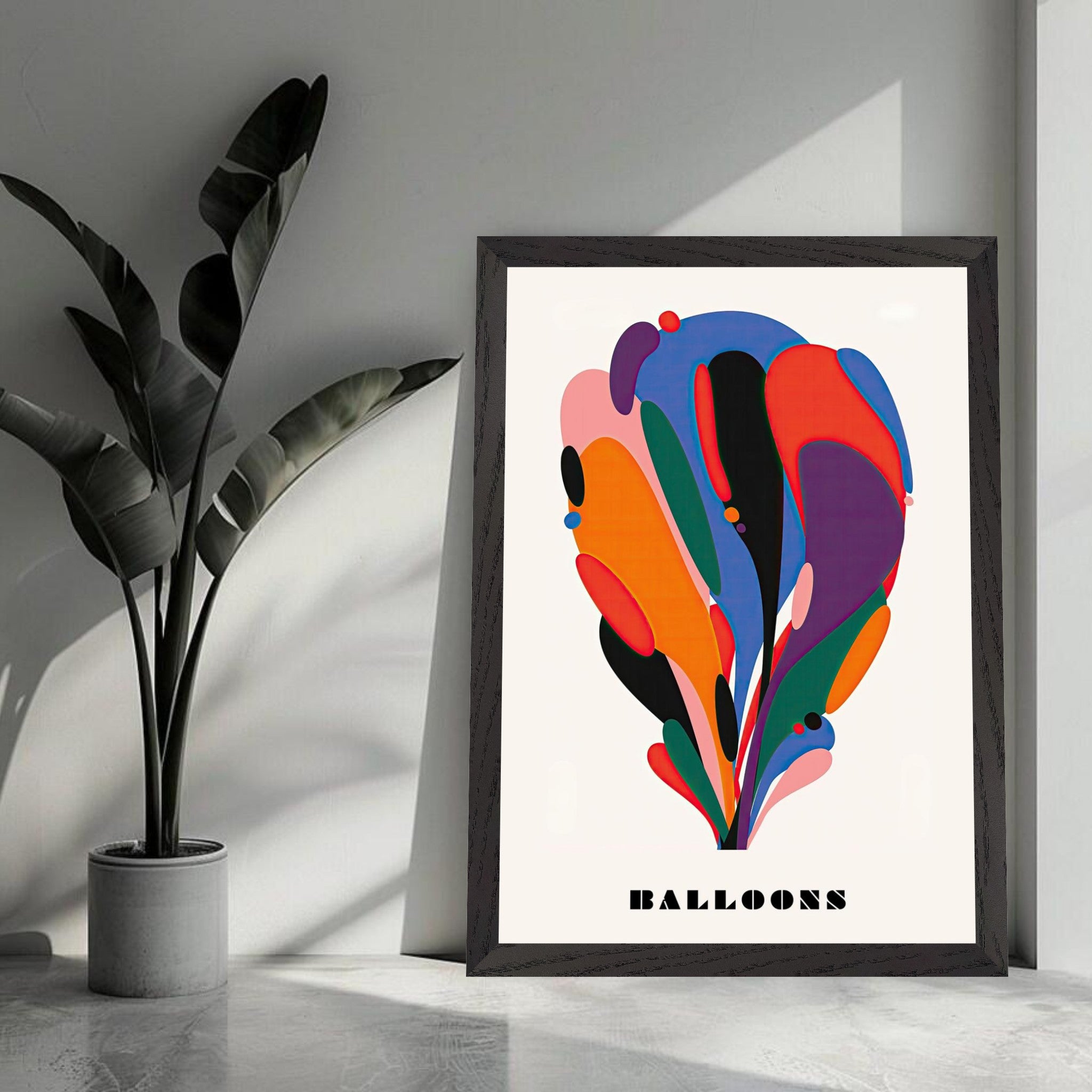 Colorful abstract balloon art vintage framed print displayed with a leafy plant in modern interior.