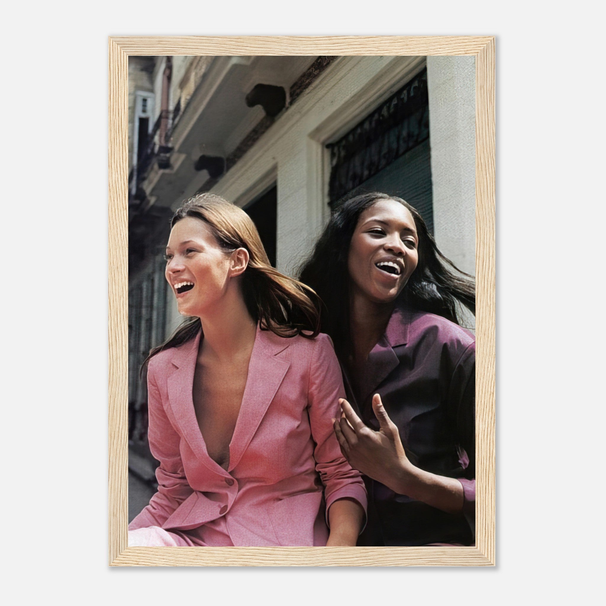 Naomi Campbell and Kate Moss framed print capturing their joyful fashion moment in vibrant outfits.