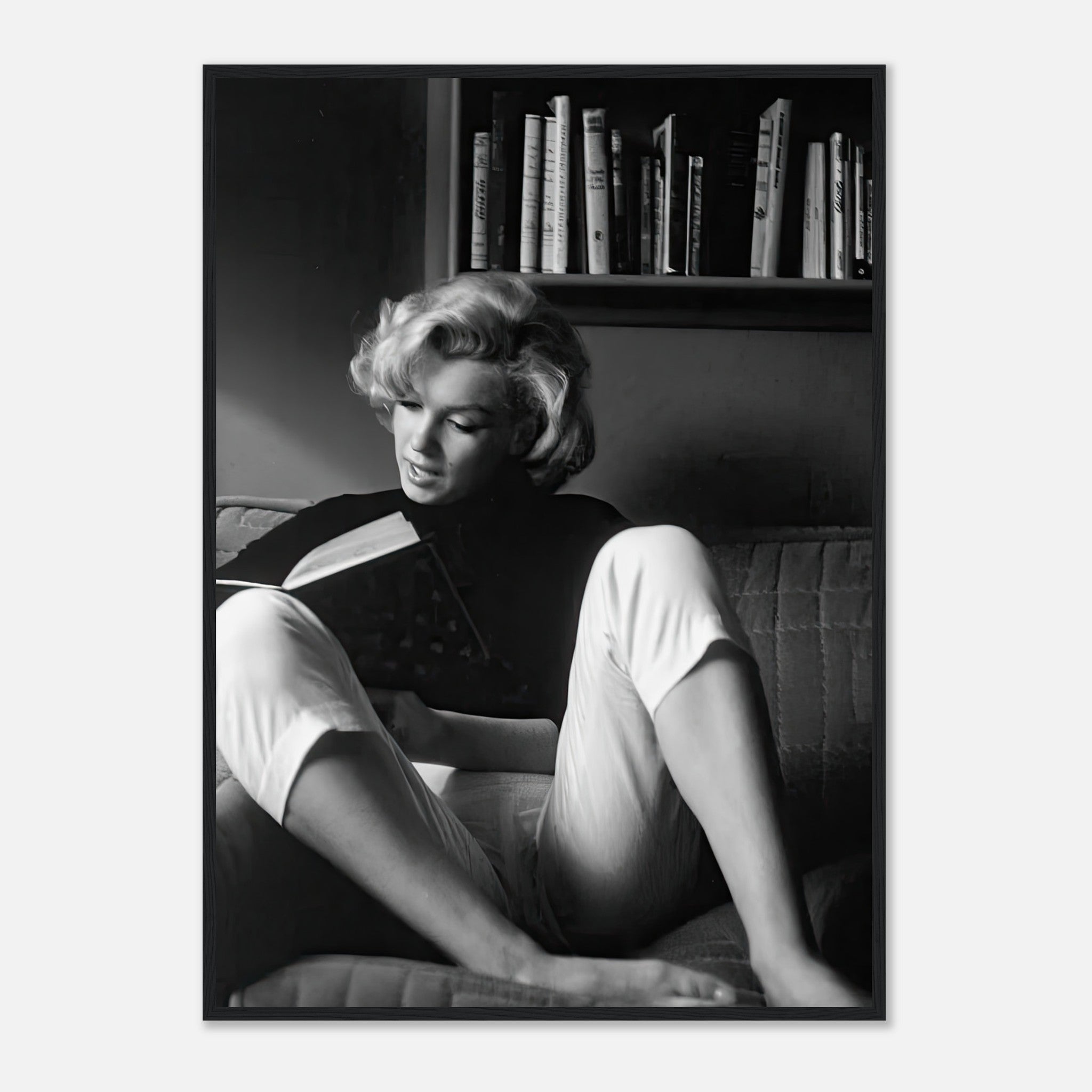 Marilyn Monroe reading at home in a black-and-white framed print, showcasing elegance and classic Hollywood charm.