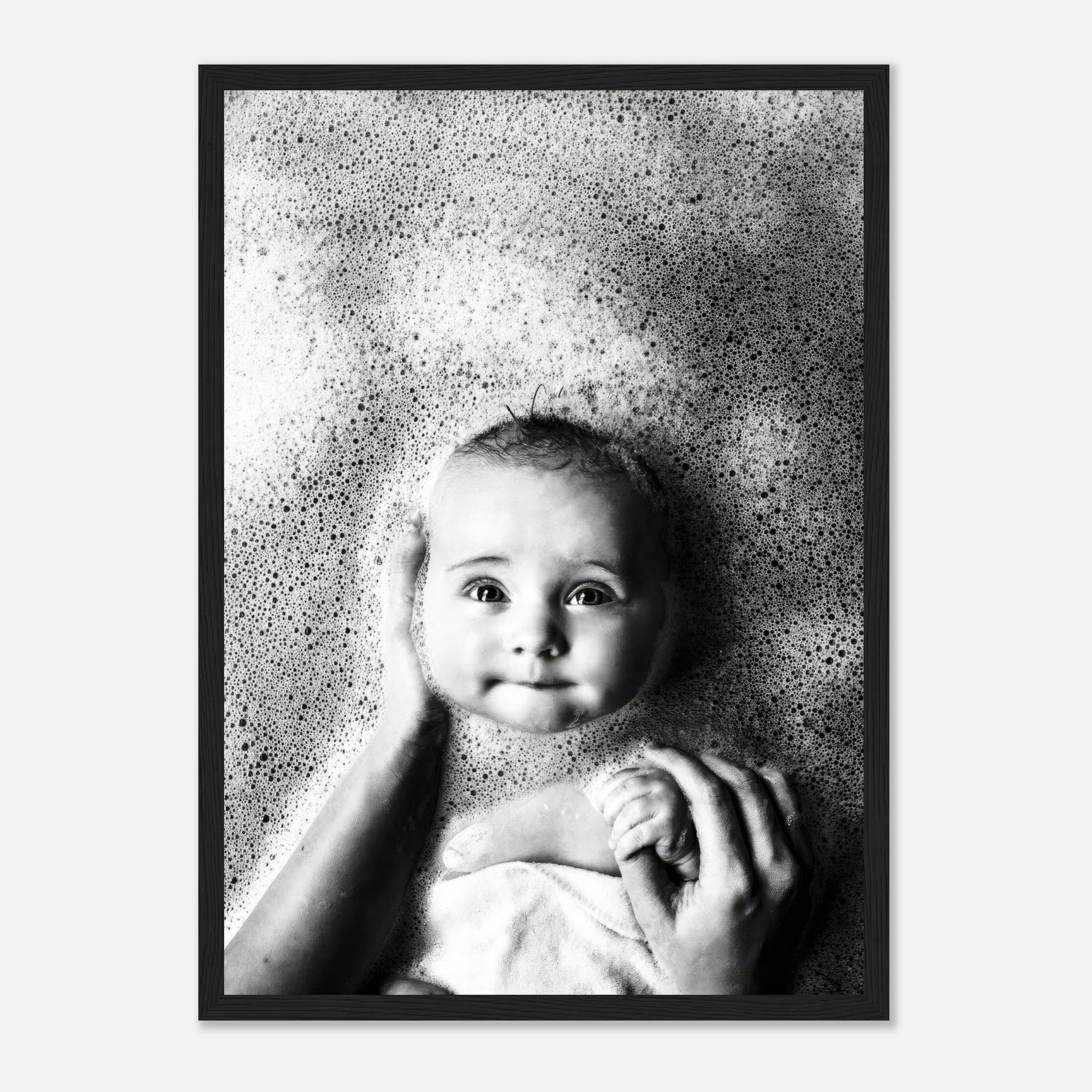 Black-and-white framed print of a baby in a bubble bath with a serene expression, perfect for nursery decor.