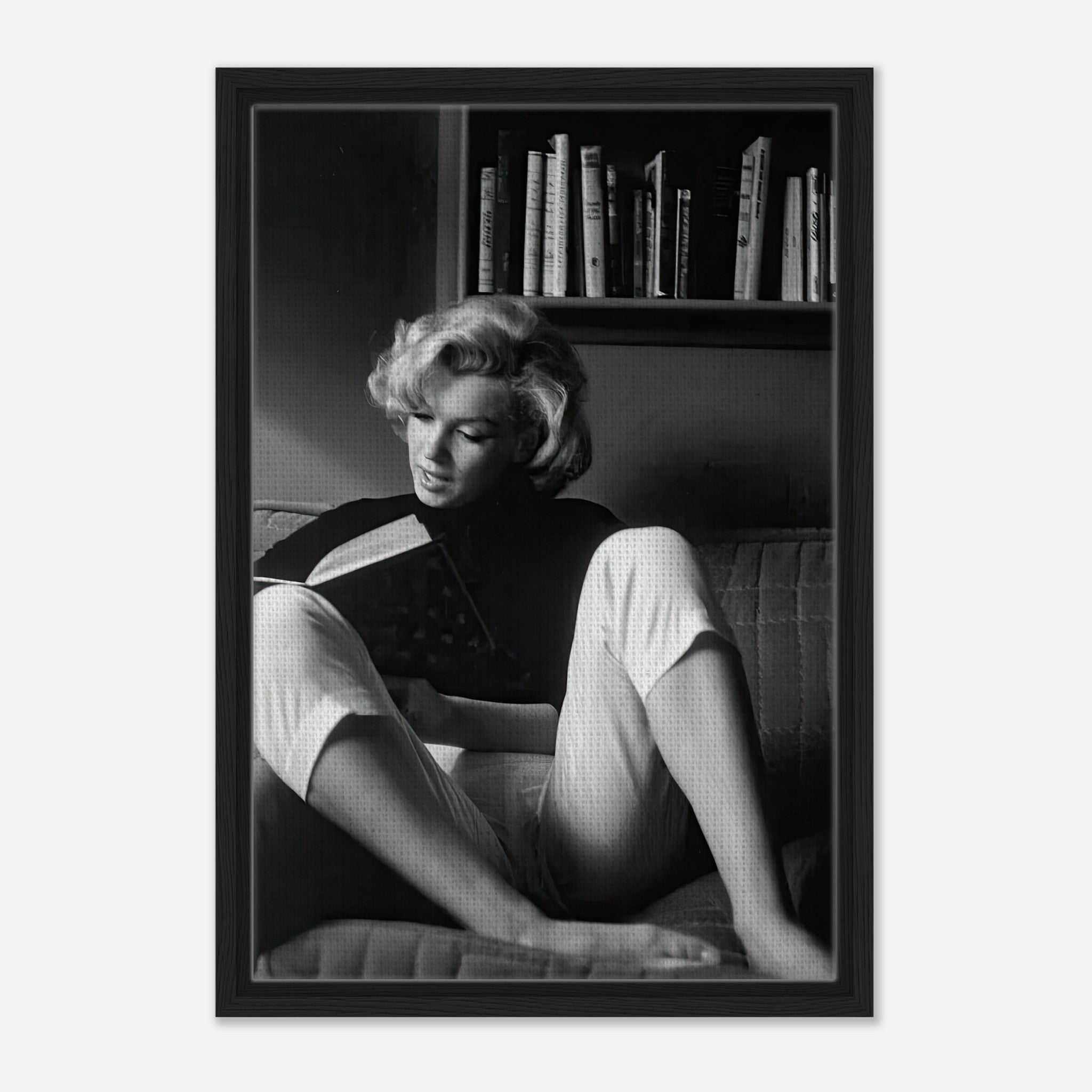 Marilyn Monroe reading at home in black-and-white framed canvas, showcasing elegance and timeless allure.