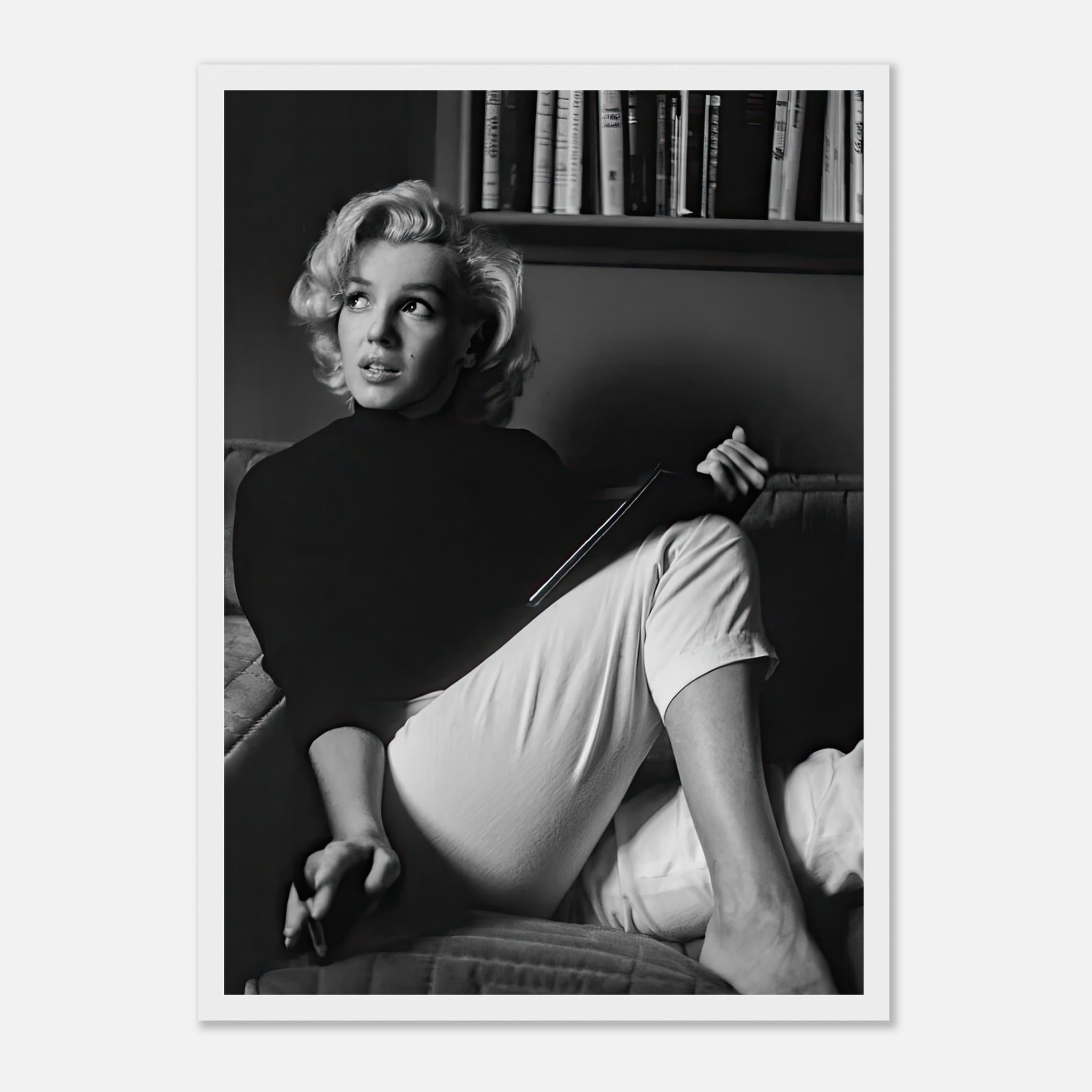 Marilyn Monroe reading a book in black-and-white framed print, adding vintage glamour to any space.