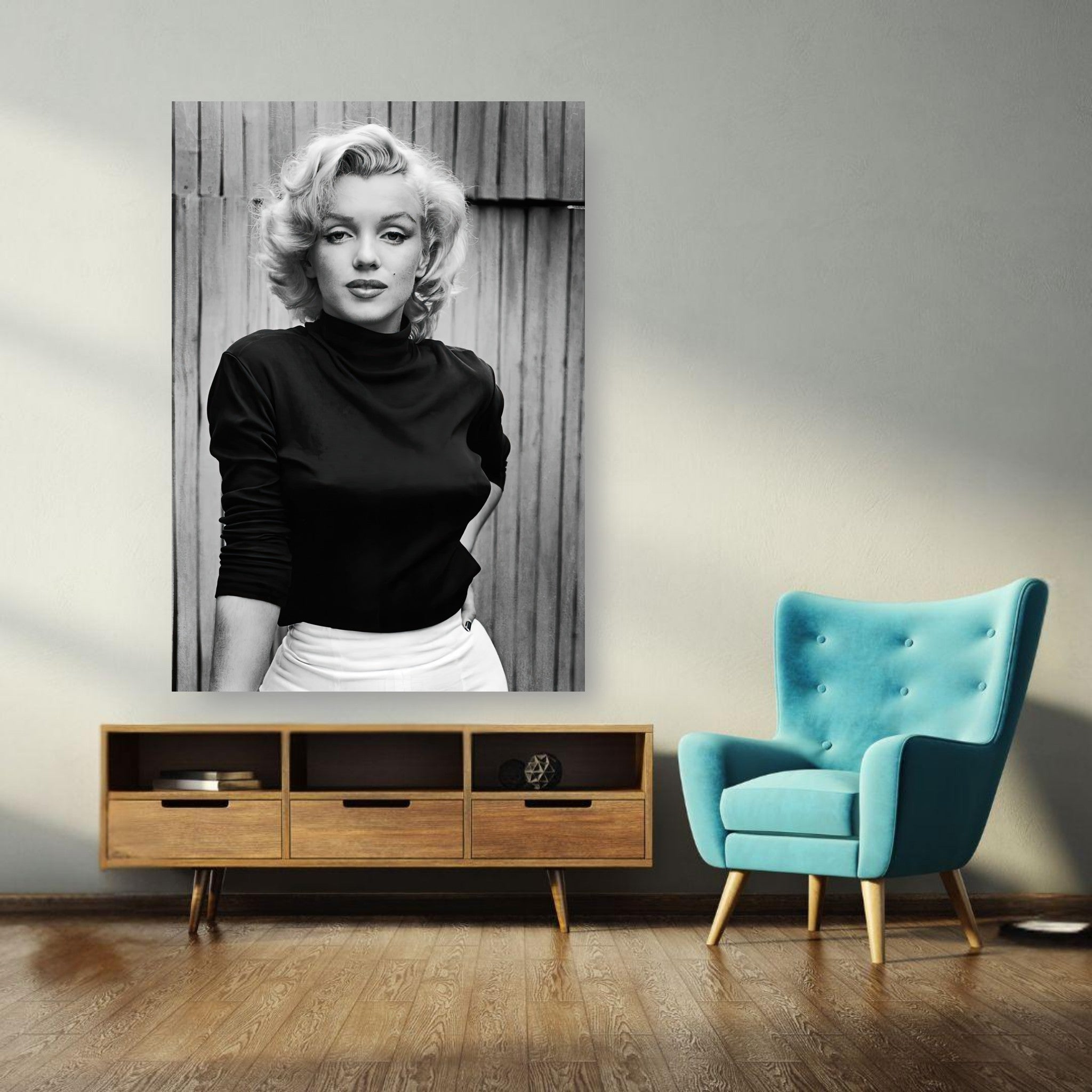 Marilyn Monroe portrait poster in black and white, displayed above a modern wooden console and teal chair.