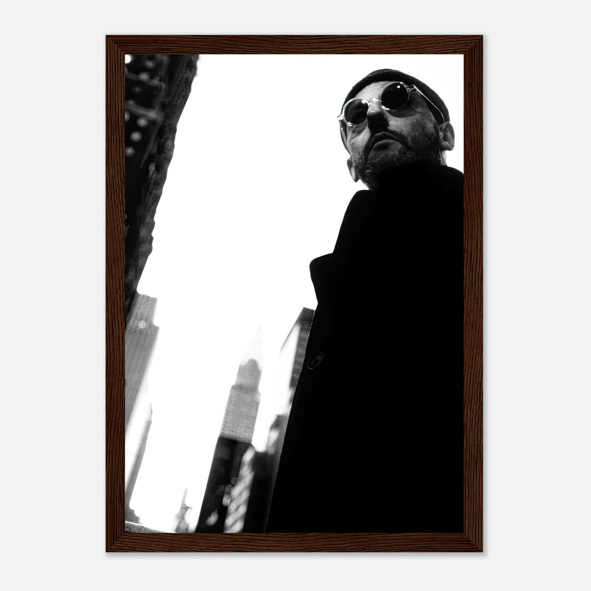 Leon Photography framed print of Jean Reno in black and white with urban backdrop, showcasing cinematic artistry.