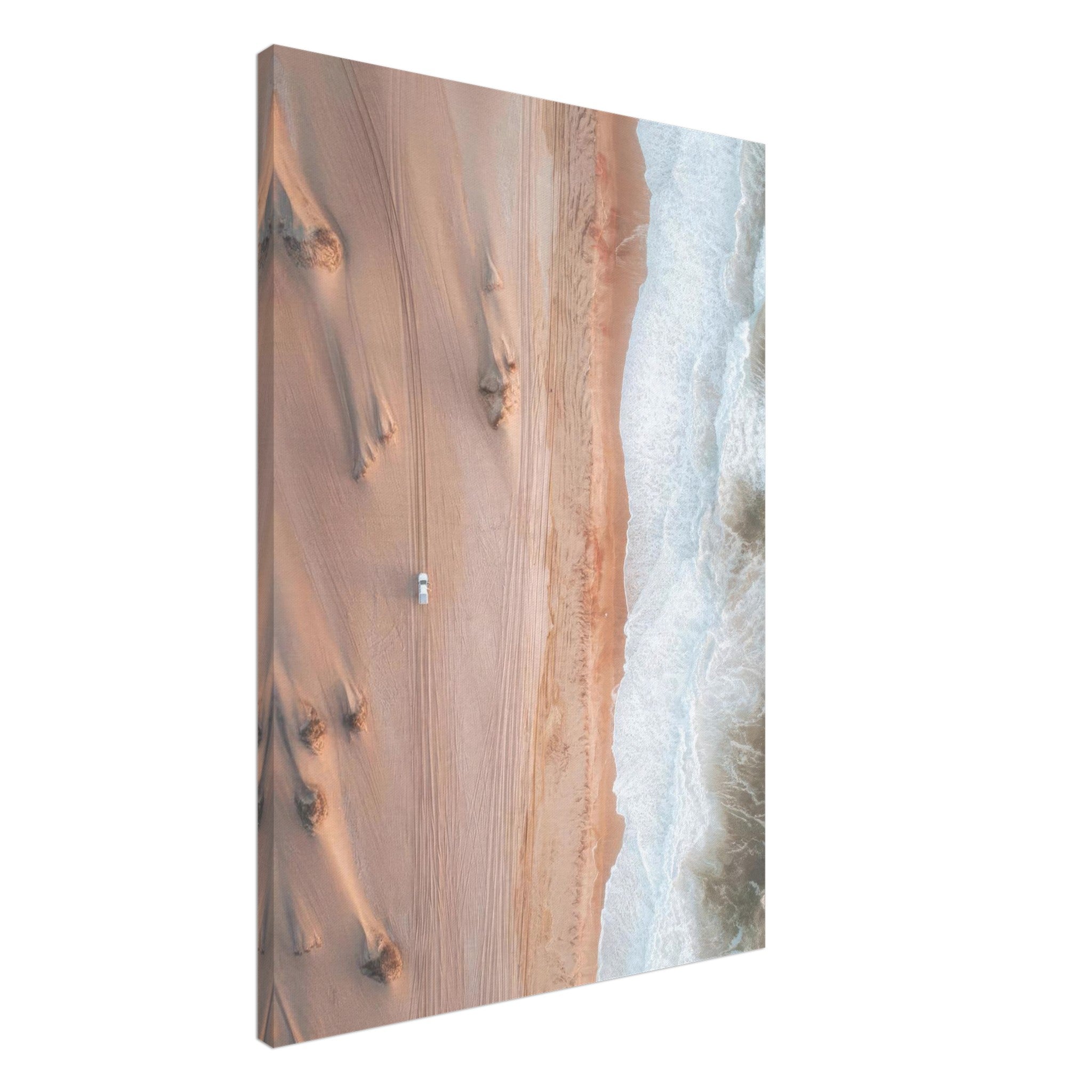 Aerial view of desert sand dunes merging with ocean waves in a stunning canvas print.