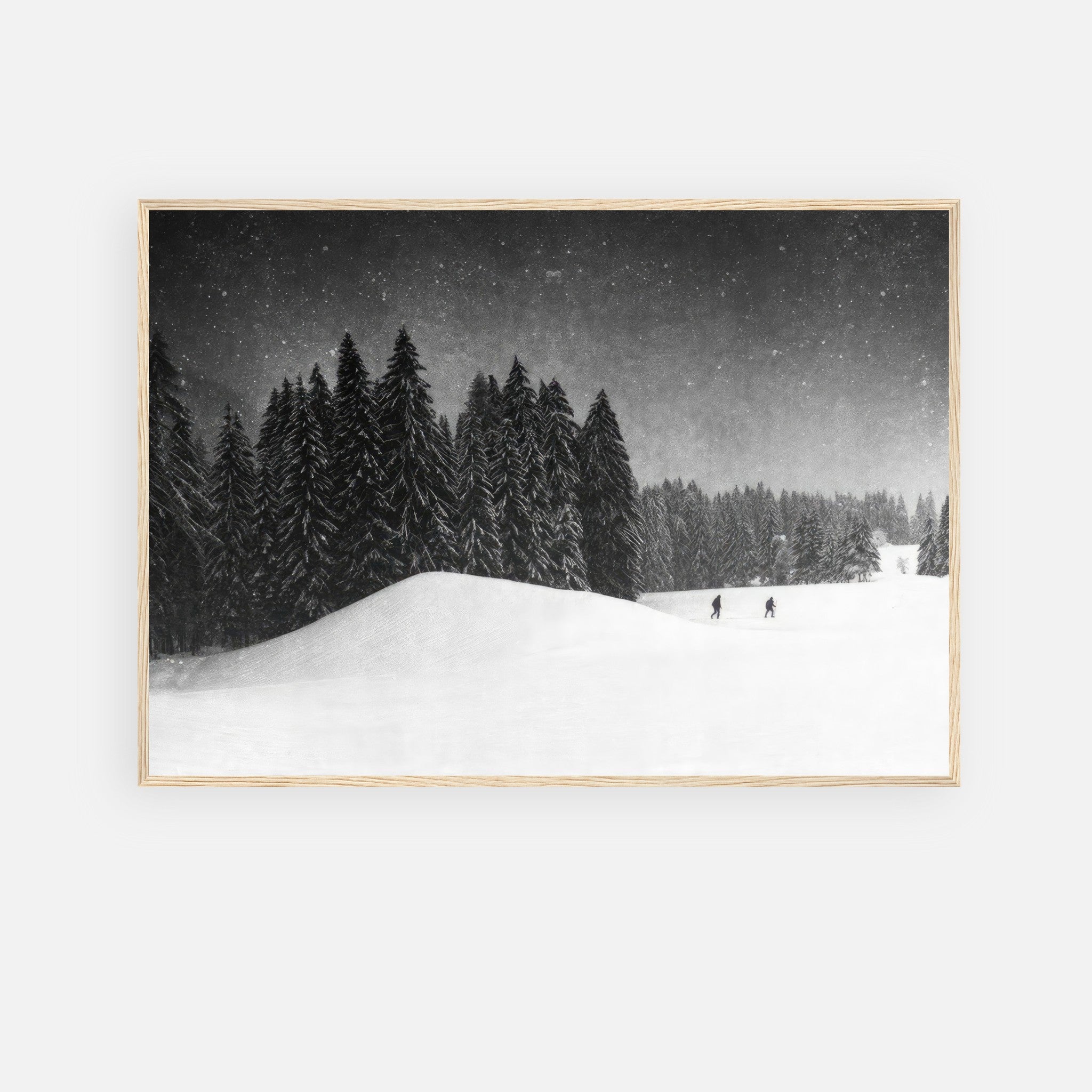 Winter Crossing framed print showcasing serene black-and-white snowy forest with skiers on a tranquil winter landscape.