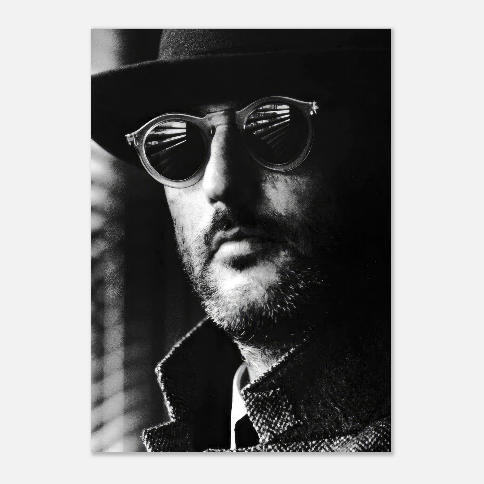Black-and-white portrait of Leon from Jean Reno, showcasing cinematic charm with sunglasses and a hat.