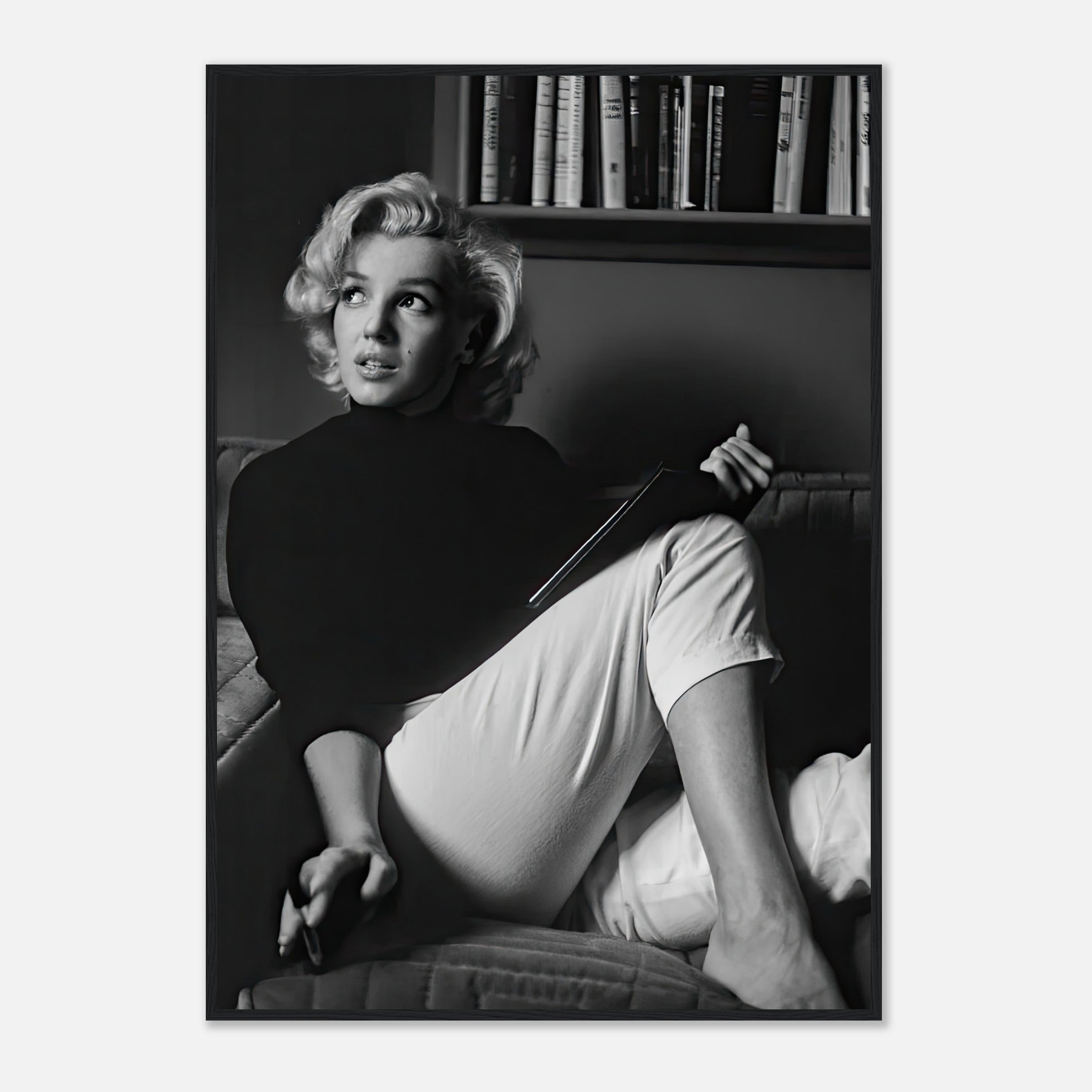 Marilyn Monroe reading a book in black-and-white framed print, adding vintage charm to any decor.