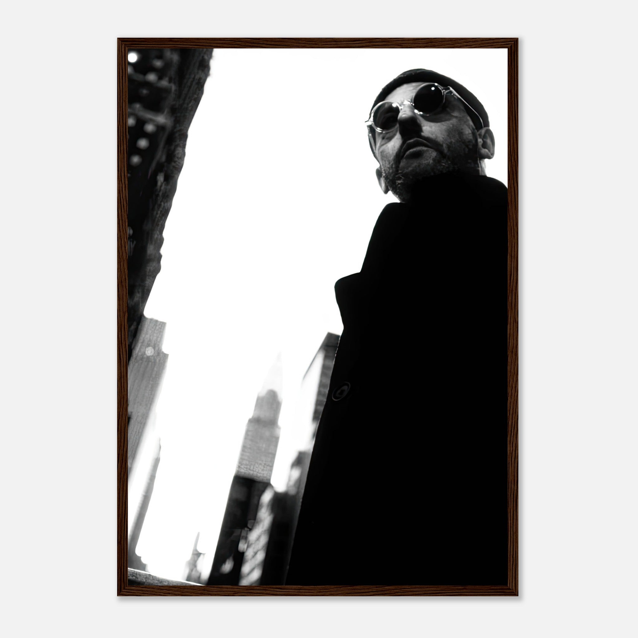 Leon Photography Jean Reno framed print featuring a stylish man in sunglasses against a city skyline in black and white.