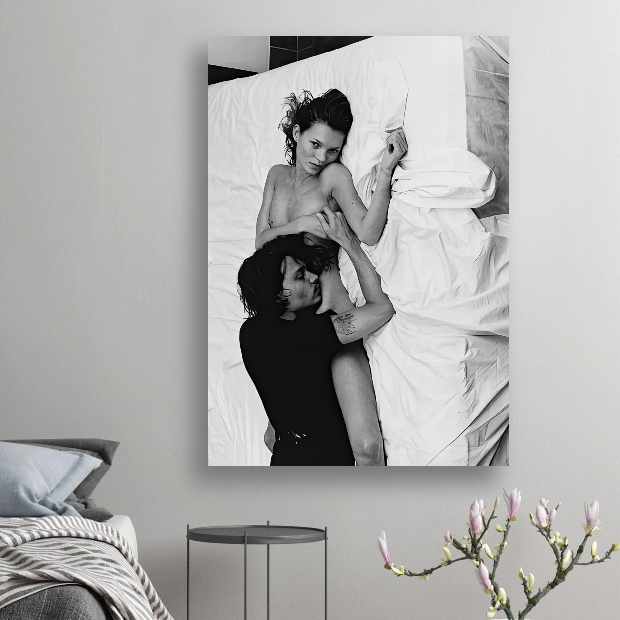 Black-and-white poster of Kate Moss and Johnny Depp in an intimate pose on a white bed, capturing 1990s romance.