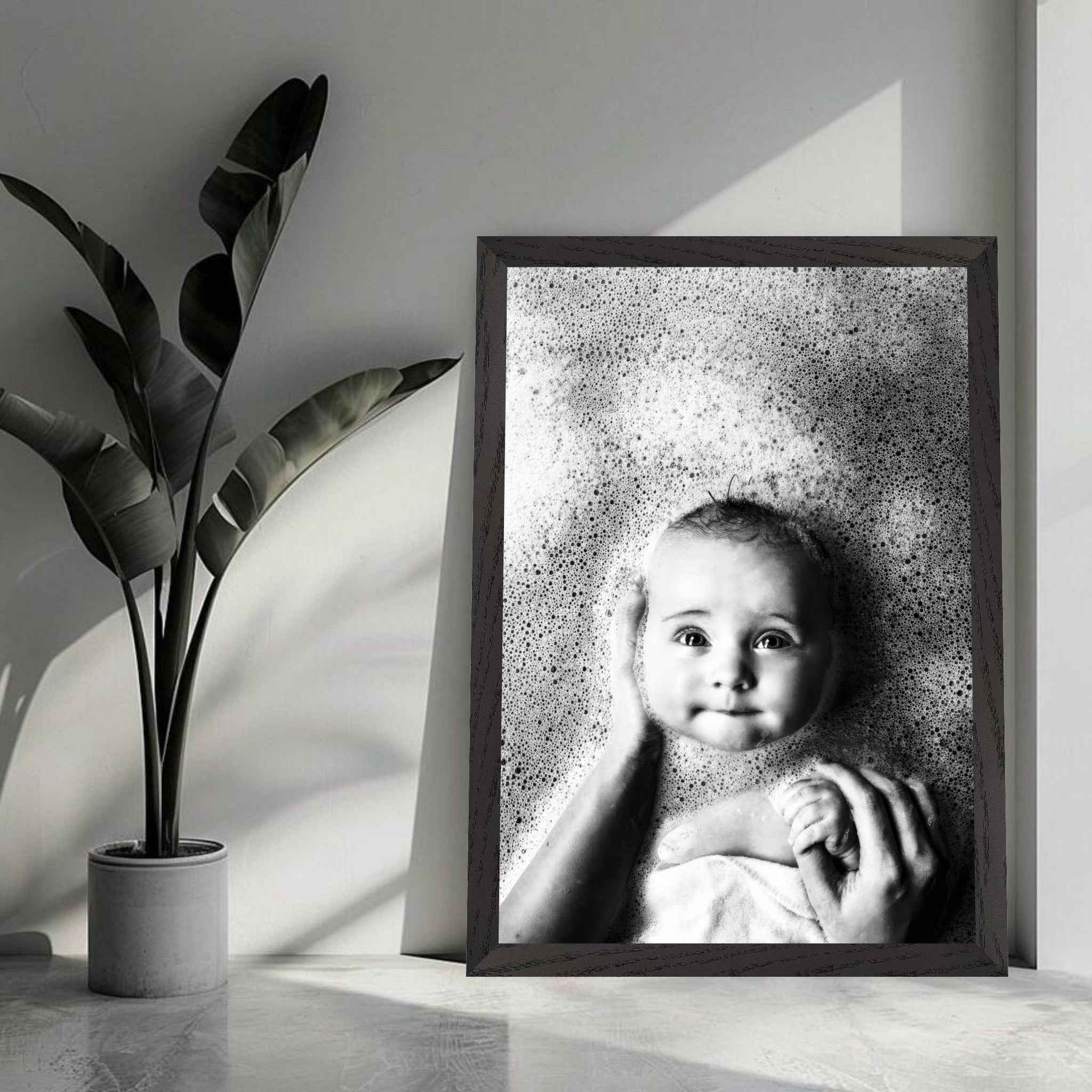 Black and white vintage framed print of a serene baby in bubbles, evoking innocence and nostalgia.