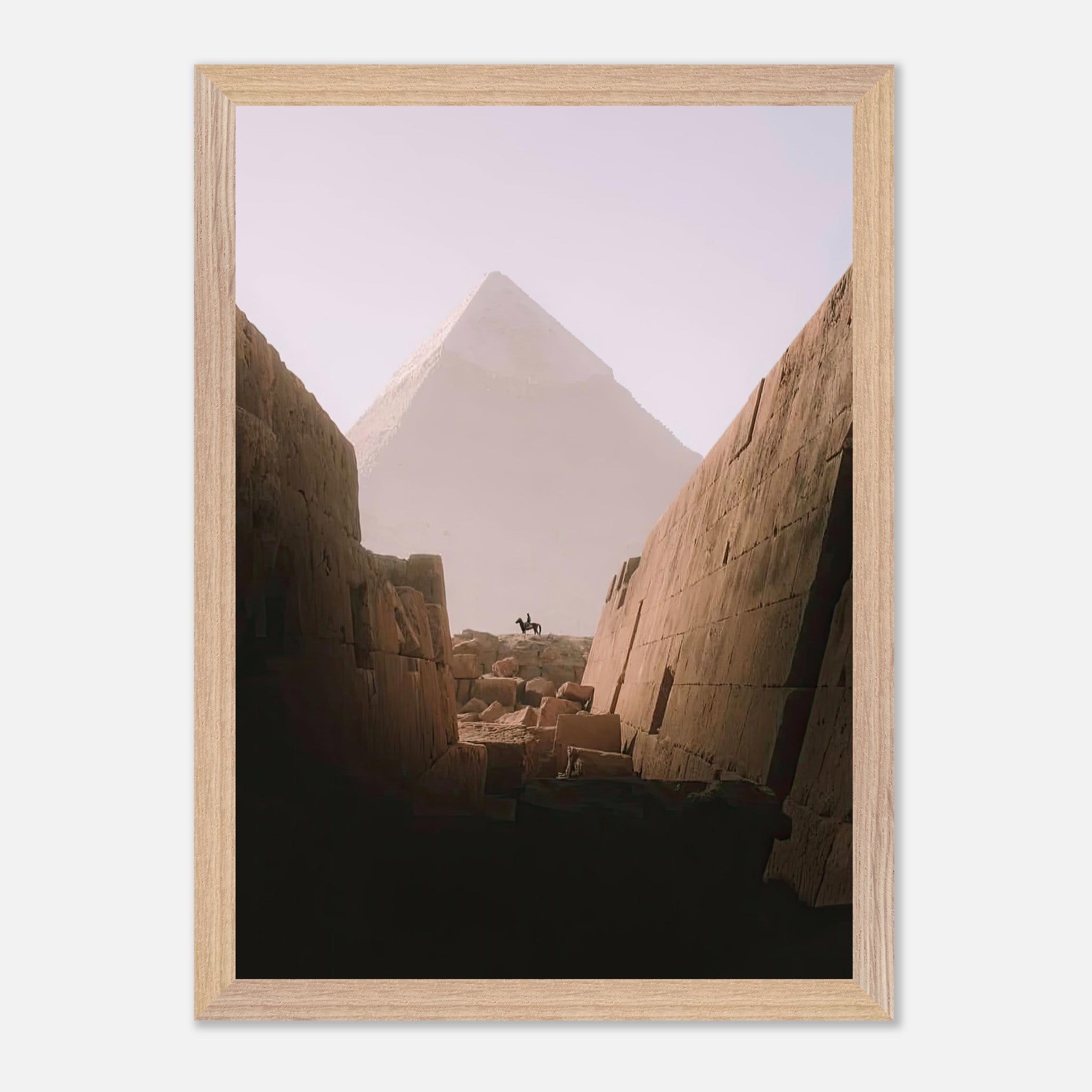 Vintage framed print of a lone rider on horseback with the Great Pyramid of Giza in the background.