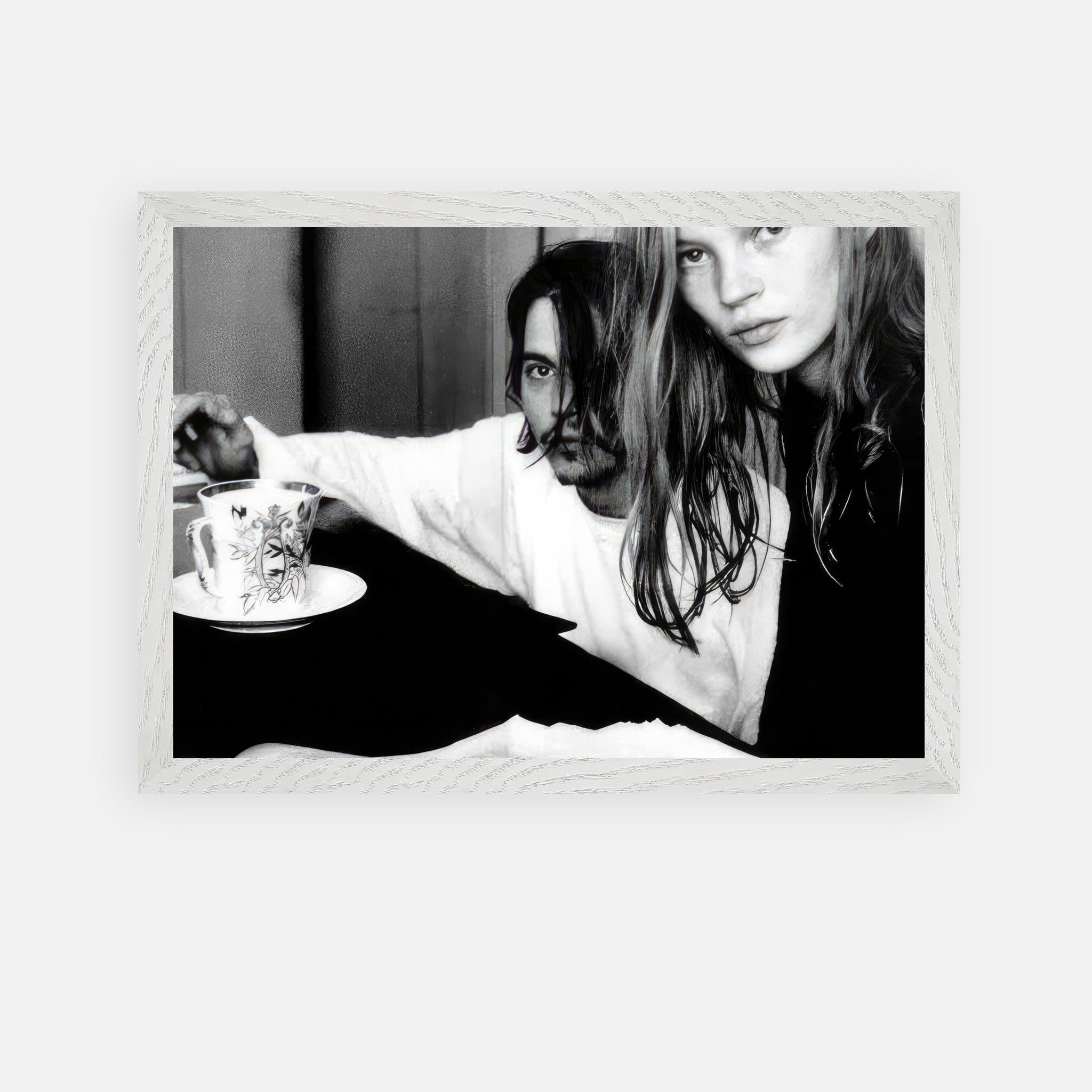 Vintage framed art of Johnny Depp and Kate Moss, capturing 90s rebellion and romance in black-and-white photography.
