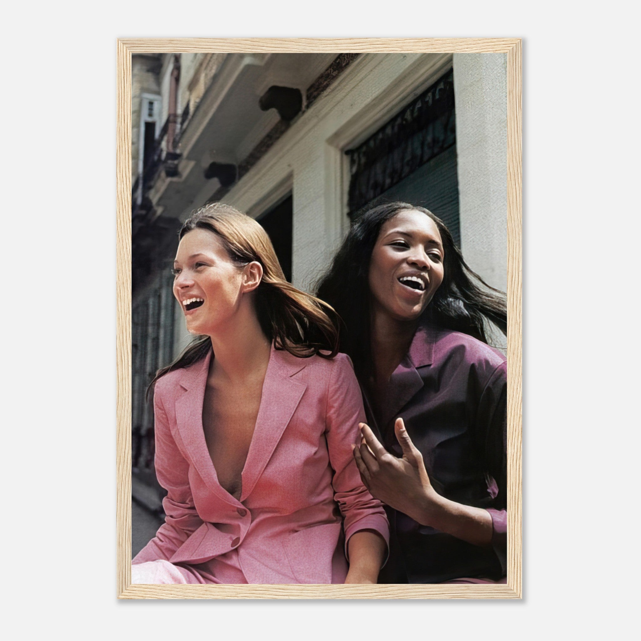 Naomi Campbell and Kate Moss framed print capturing a joyful moment in stylish suits, perfect for fashion lovers.