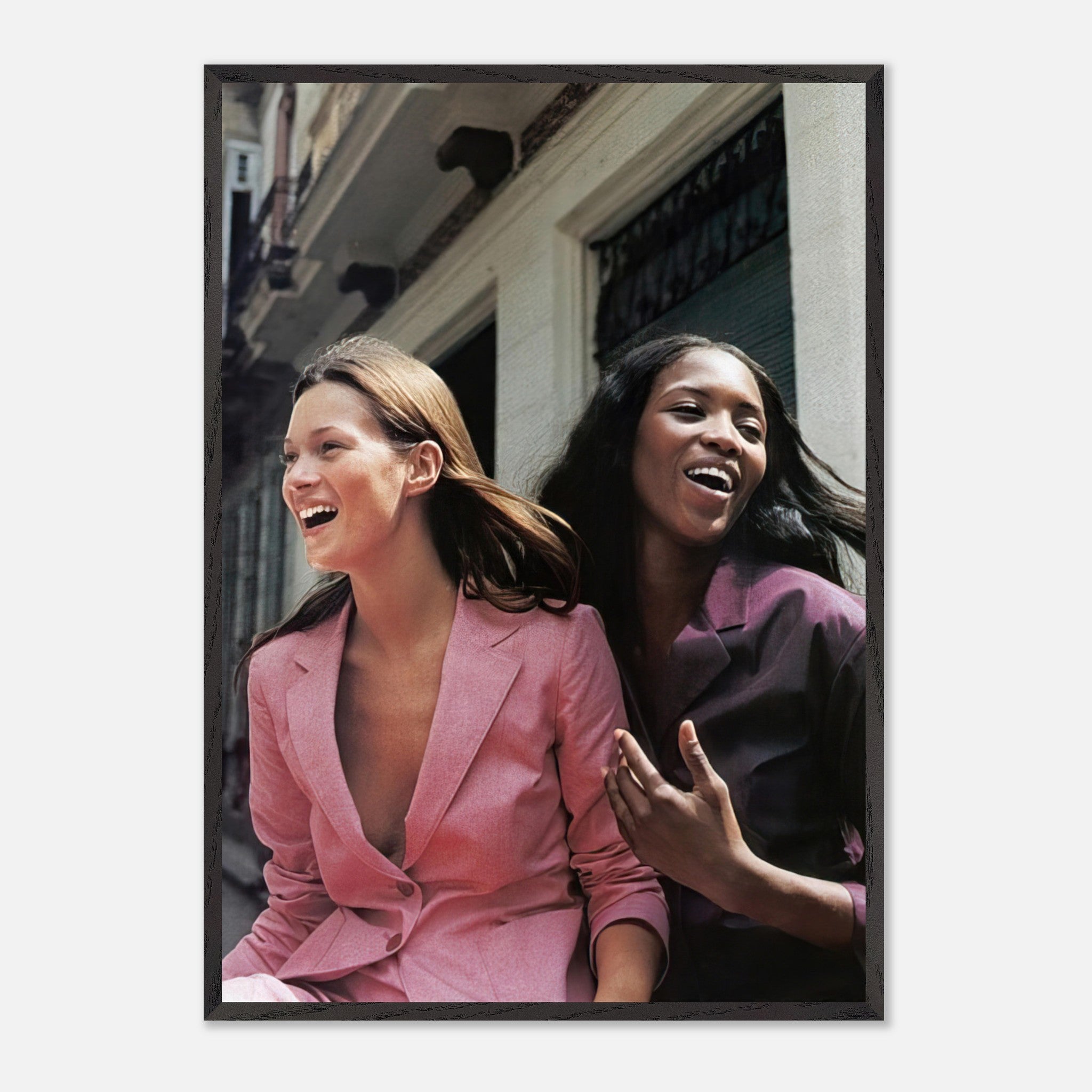 Naomi Campbell and Kate Moss laughing in vintage framed print, showcasing timeless elegance and fashion history.