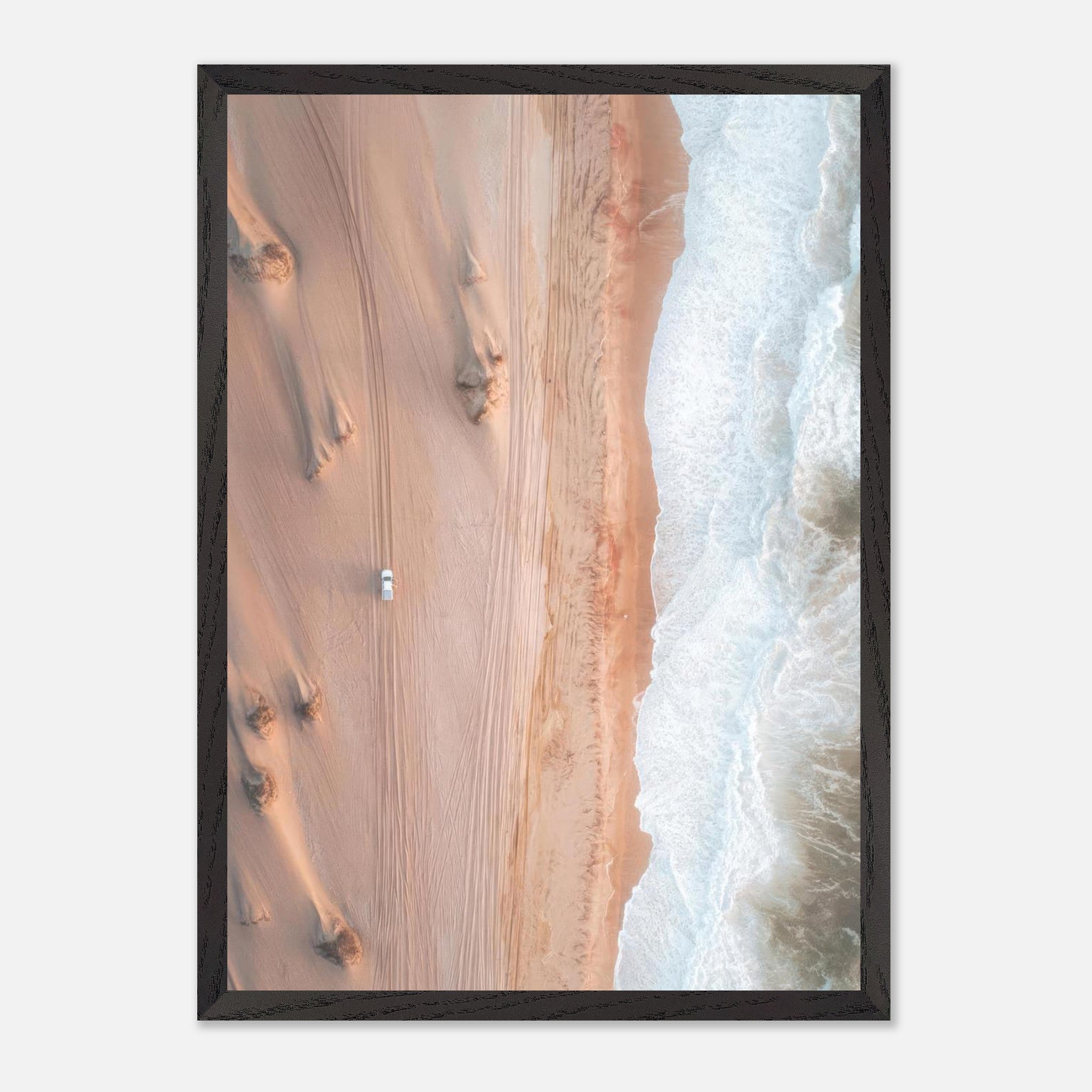 Aerial view of golden dunes meeting the ocean, showcasing the stunning contrast of desert and sea in fine art photography.
