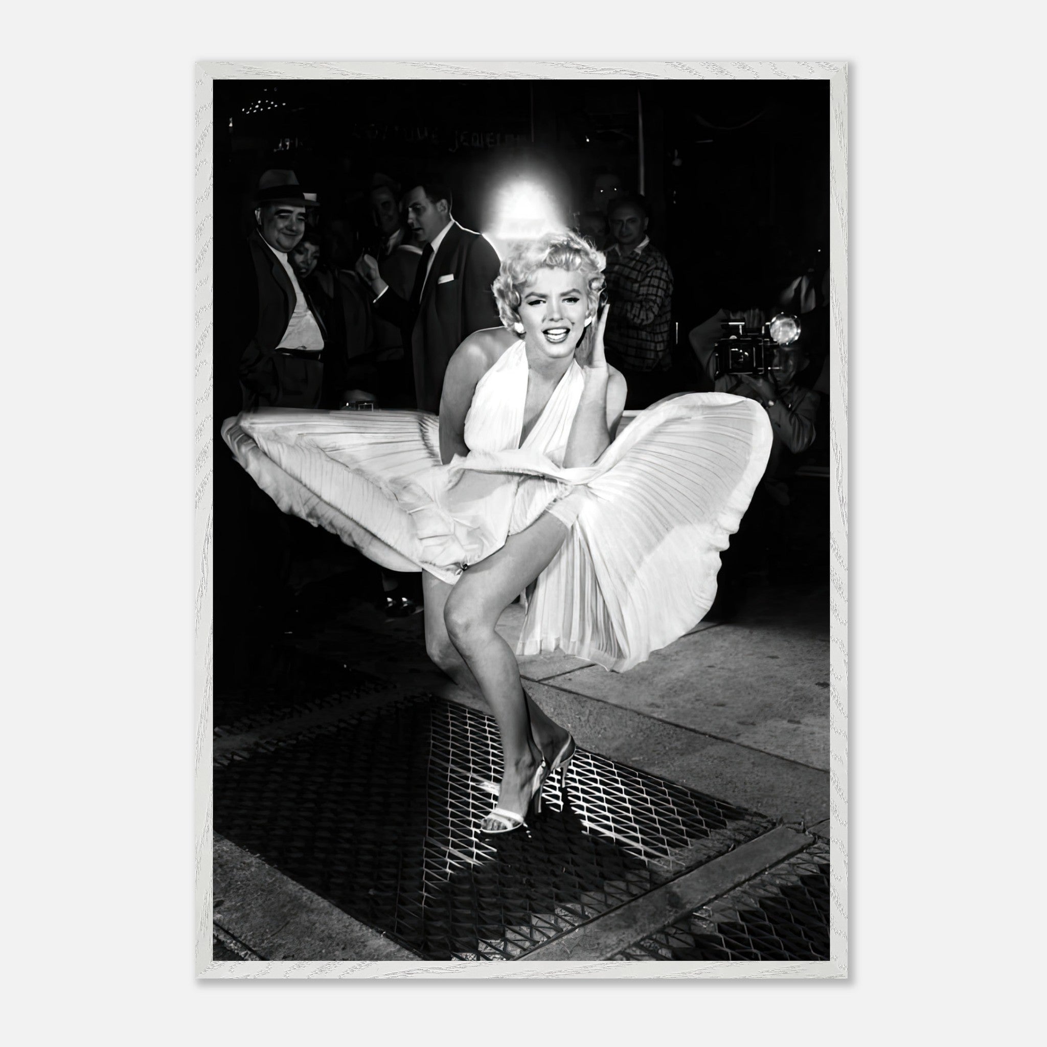 Vintage photograph of Marilyn Monroe in a white dress, playfully blown by wind, showcasing Hollywood glamour.