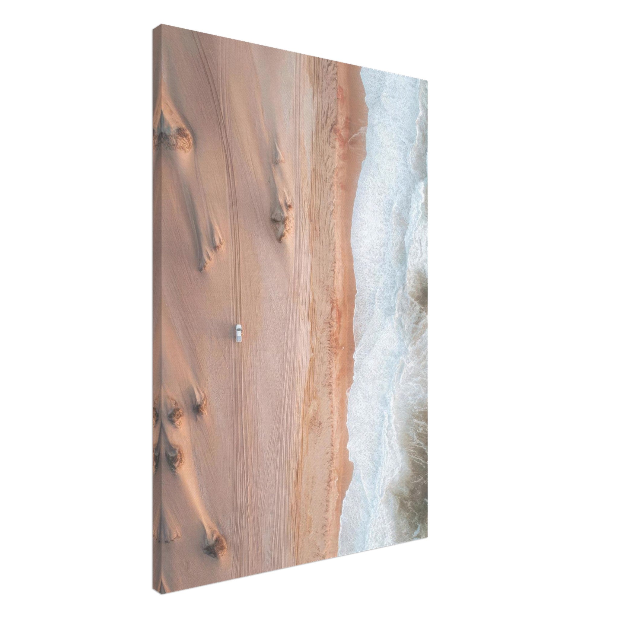 Drone photography canvas print of sandy dunes meeting ocean waves, showcasing nature's beauty in warm tones.