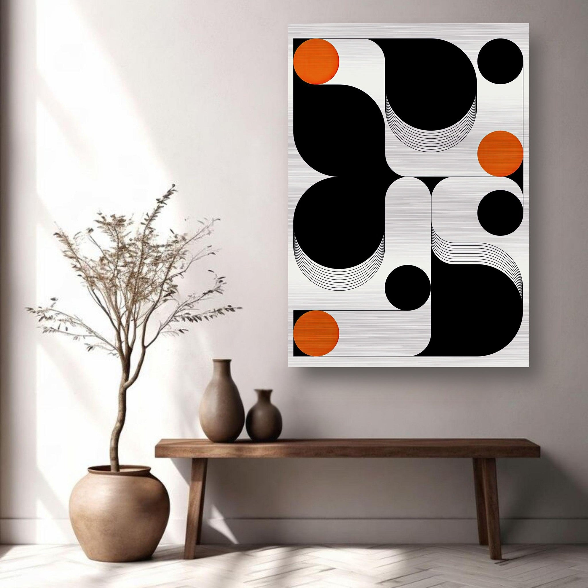 Modern geometric abstract art in black, white, and orange on brushed metal, displayed in a contemporary living space.