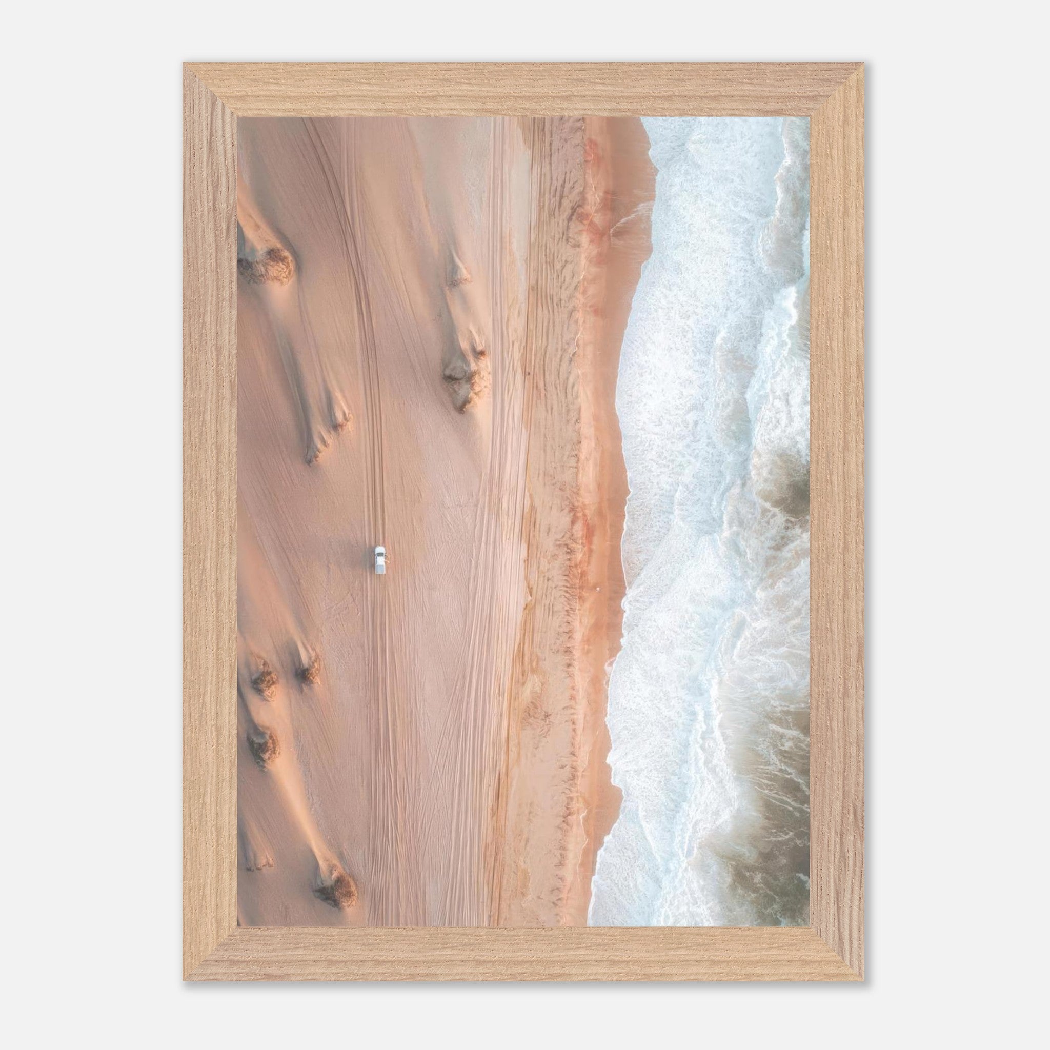Vintage framed print of aerial drone photography showing desert dunes meeting ocean waves.