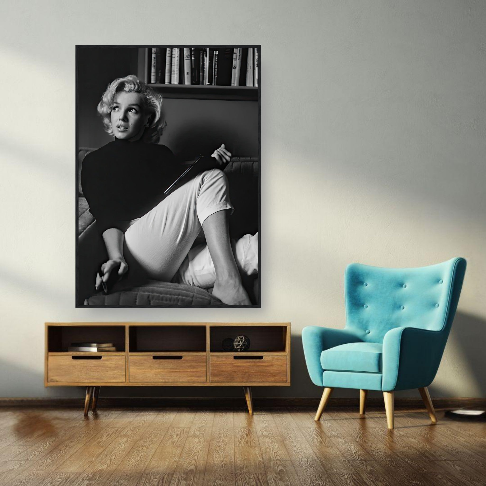 Black-and-white framed print of Marilyn Monroe reading a book, adding vintage elegance to modern decor.