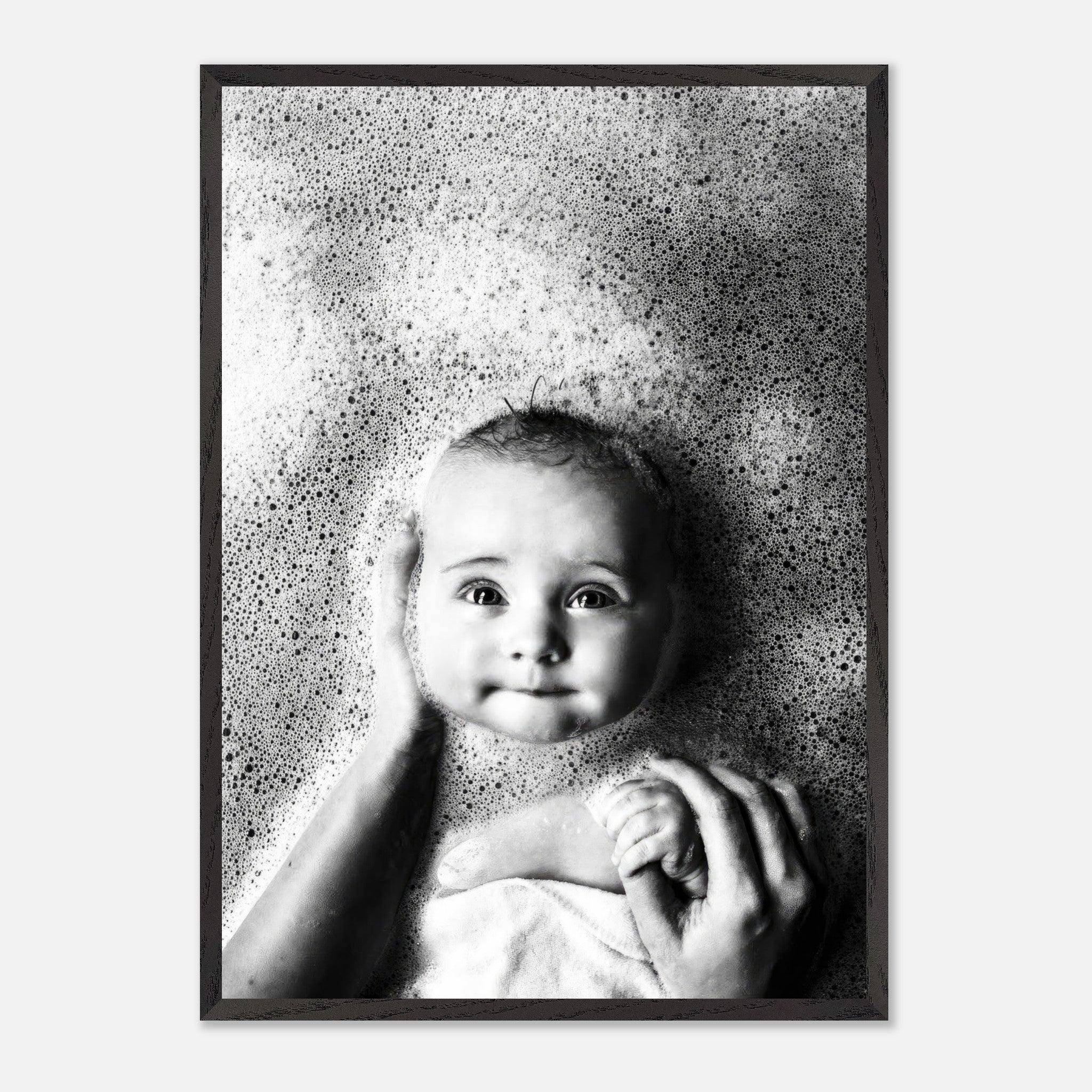 Baby bath vintage framed print featuring a joyful baby surrounded by bubbles in a serene black and white scene.