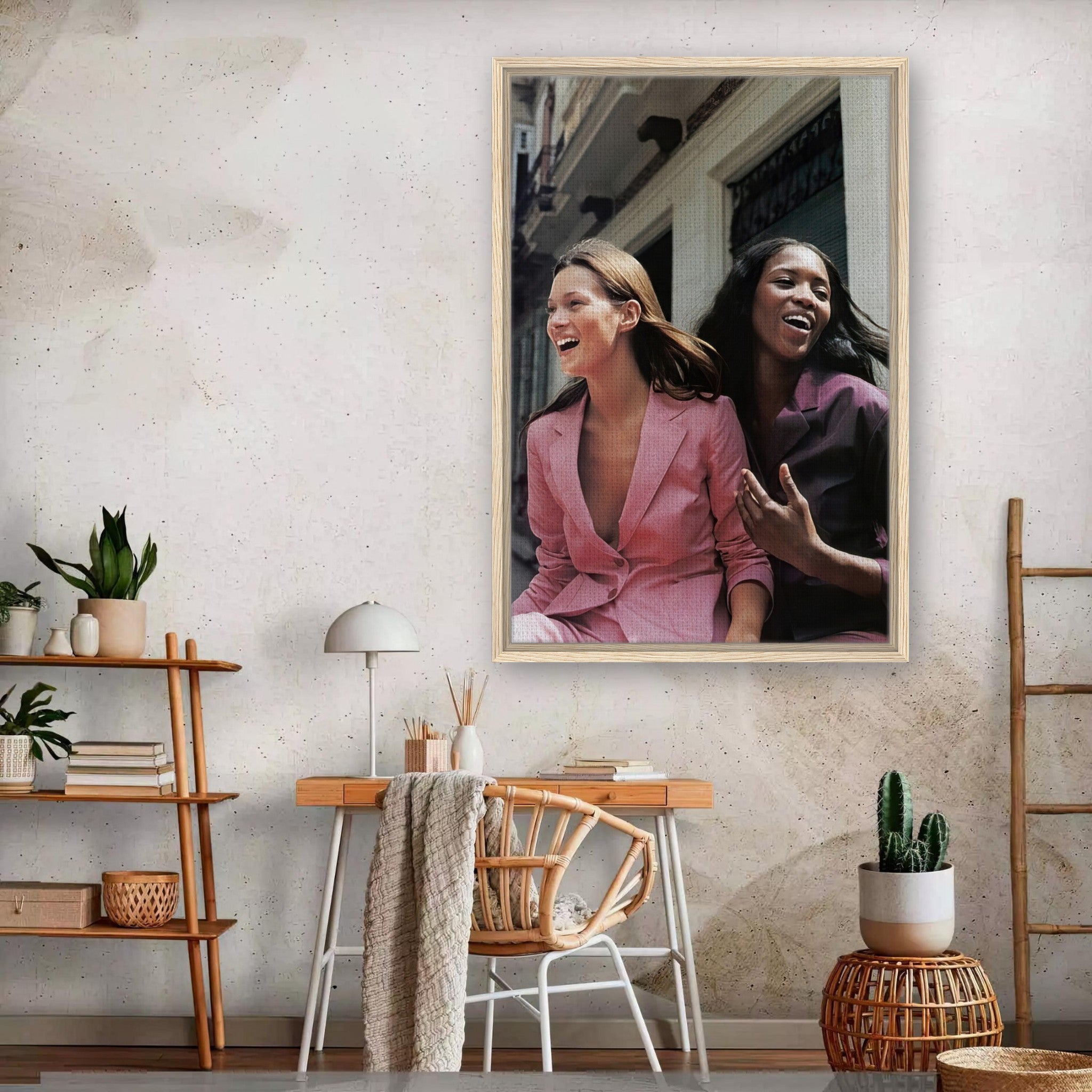 Naomi Campbell x Kate Moss framed canvas print showcasing iconic supermodels laughing in stylish attire.