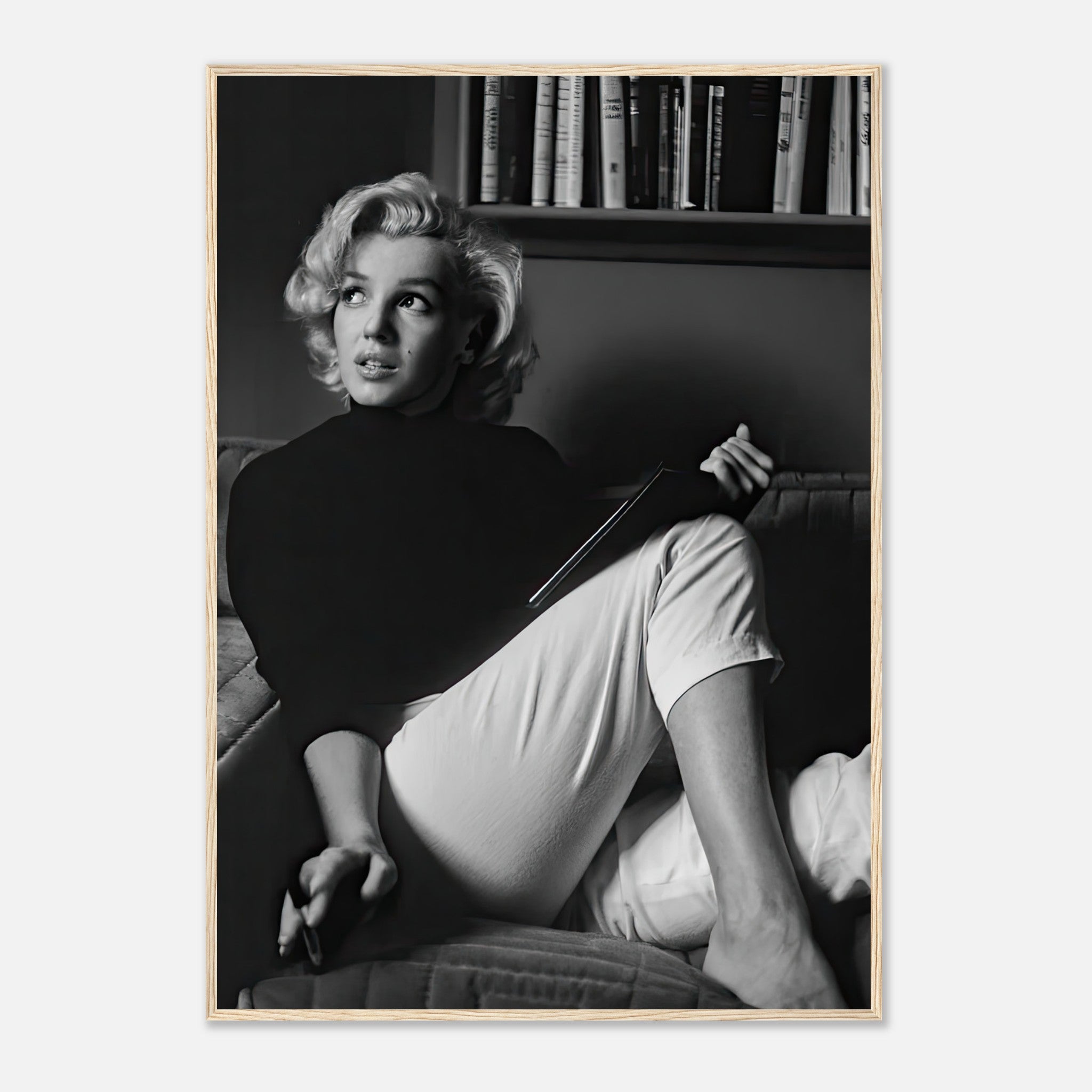 Marilyn Monroe reading a book in black-and-white framed print, showcasing vintage Hollywood elegance.