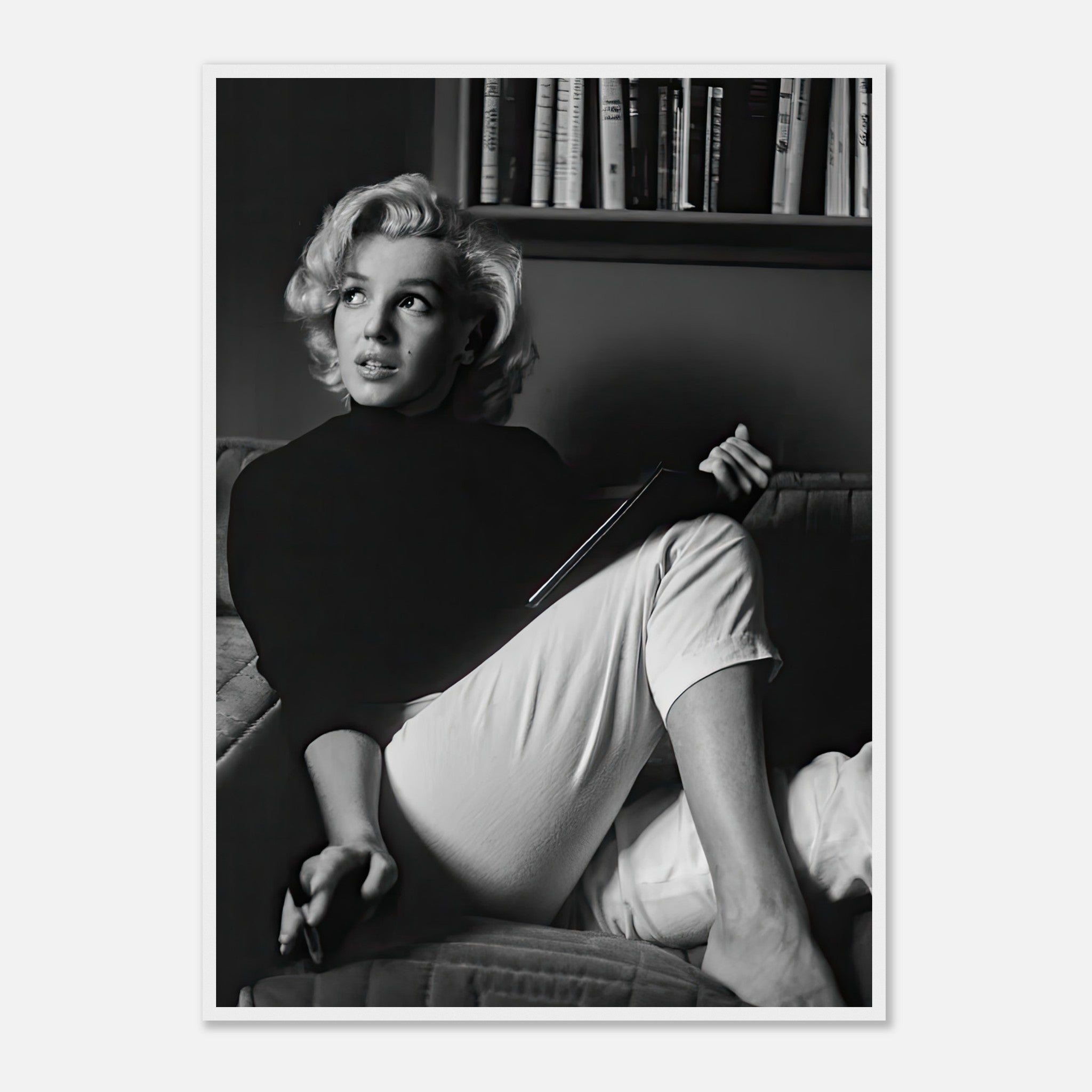 Marilyn Monroe reading a book in black-and-white, capturing vintage glamour and elegance in a framed print.