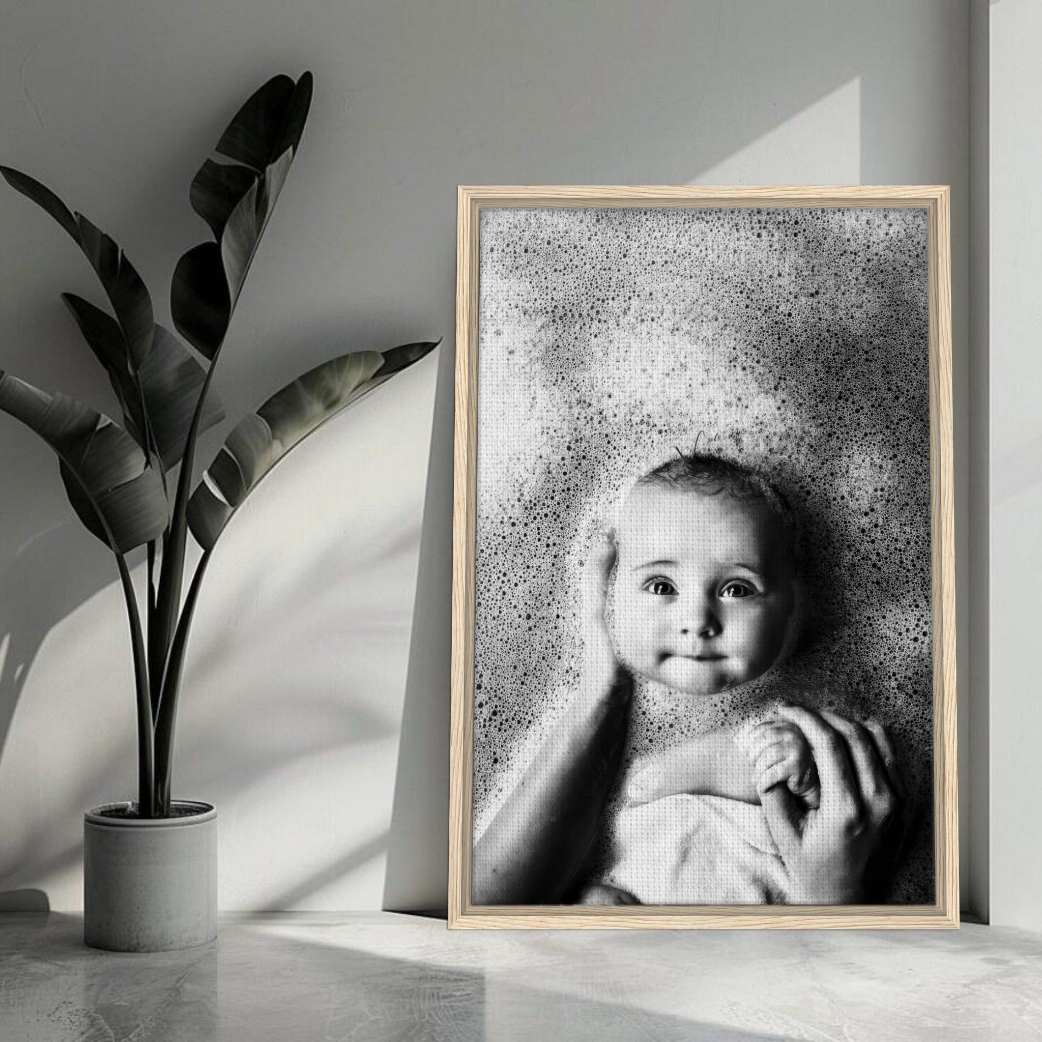Black-and-white baby bath photography framed canvas print featuring a smiling baby surrounded by bubbles.