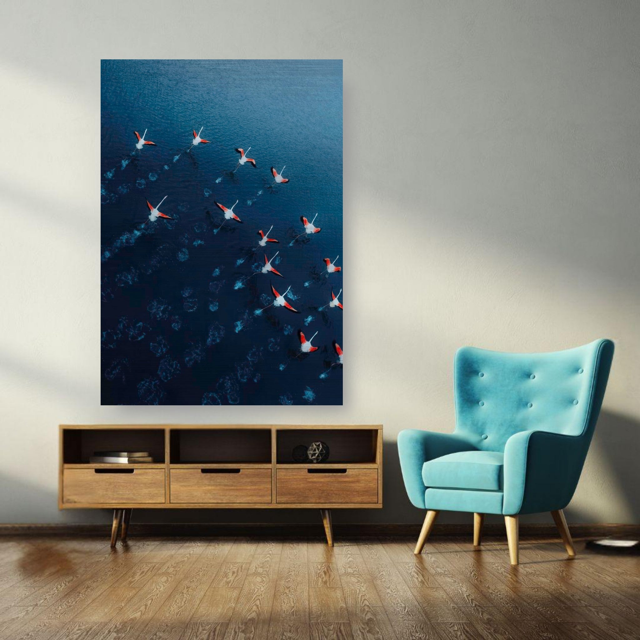 Aerial view of flamingos over deep blue waters in a stylish living room, showcasing vibrant pink and red hues.